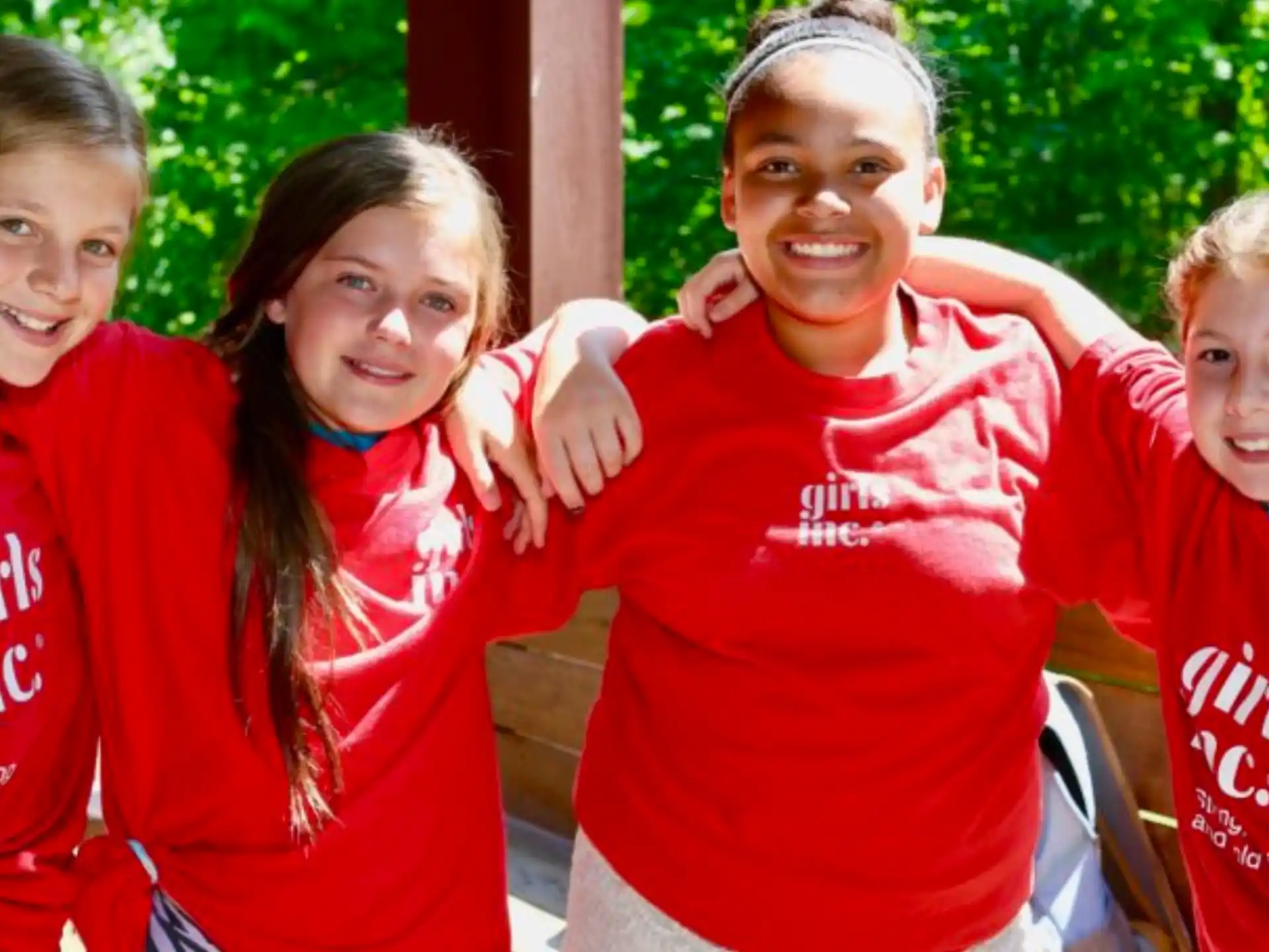 a group of children in red shirts