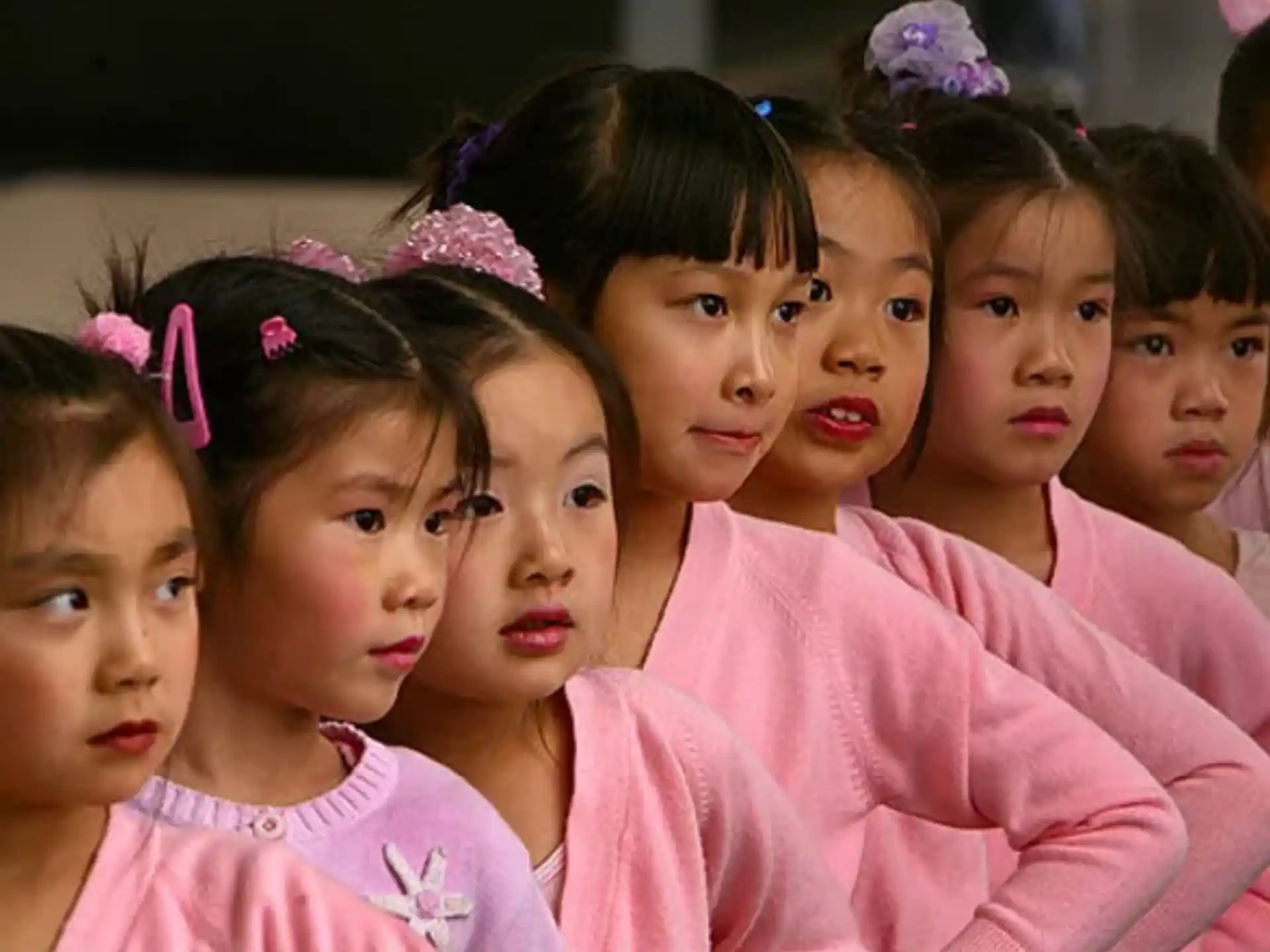 a group of girls wearing pink shirts