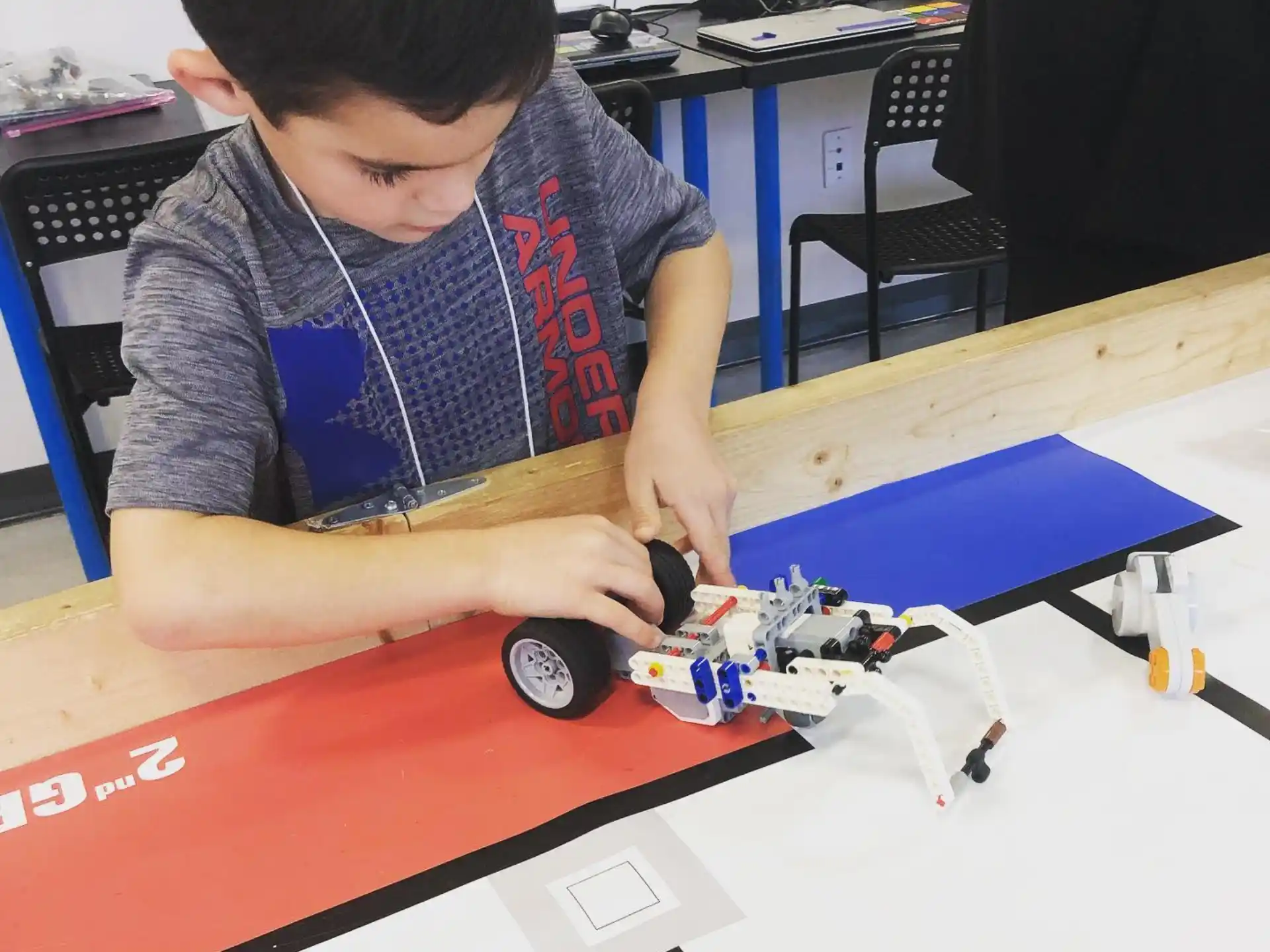 a boy playing with a toy car