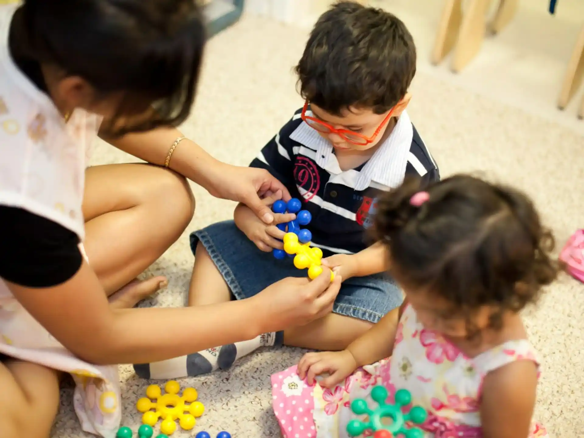 a person and a child playing with toys