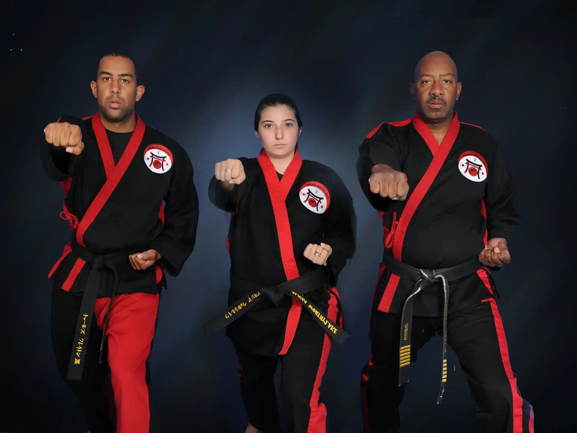 a group of men in red and black suits