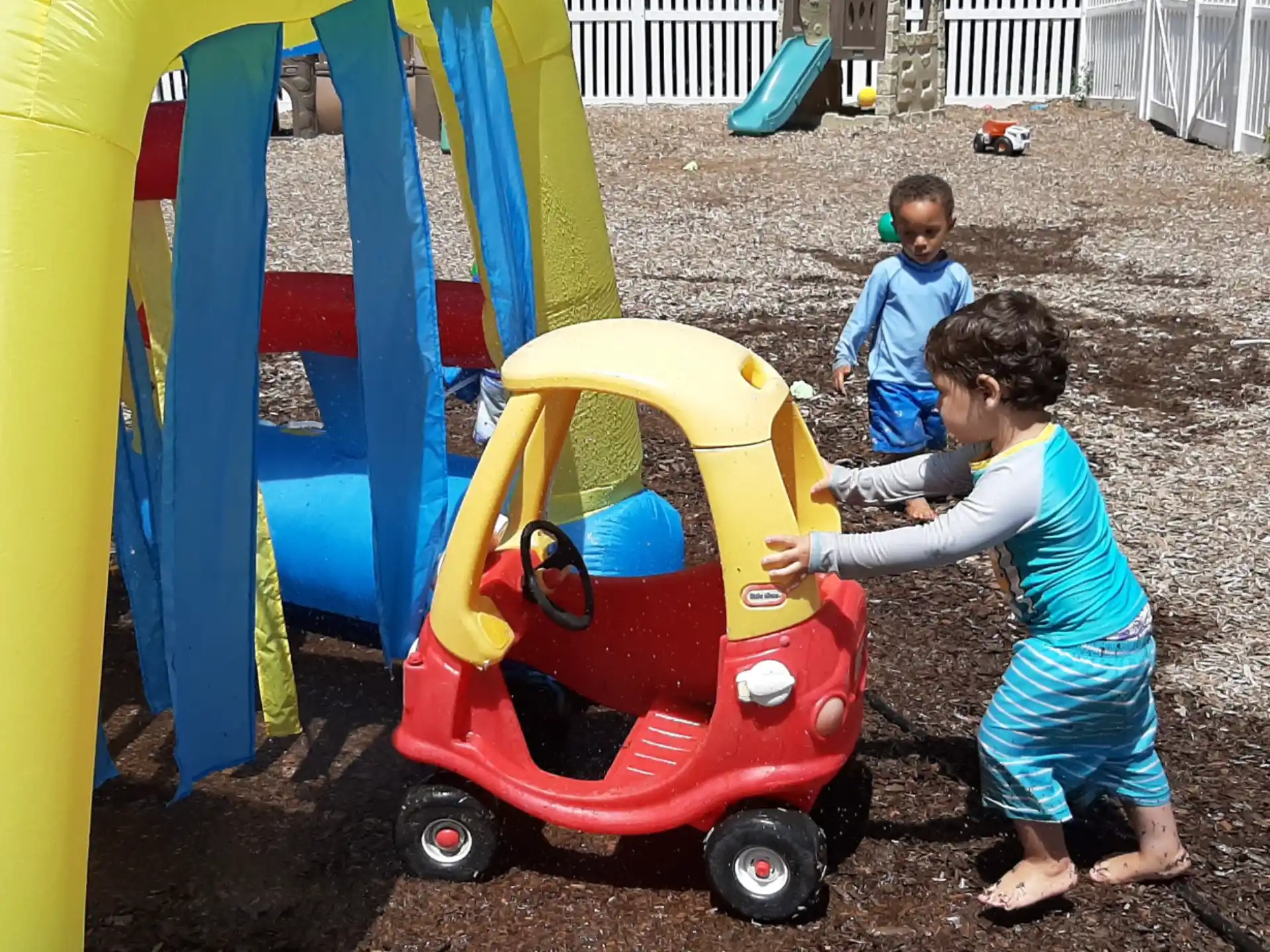 a couple of kids playing in a play area