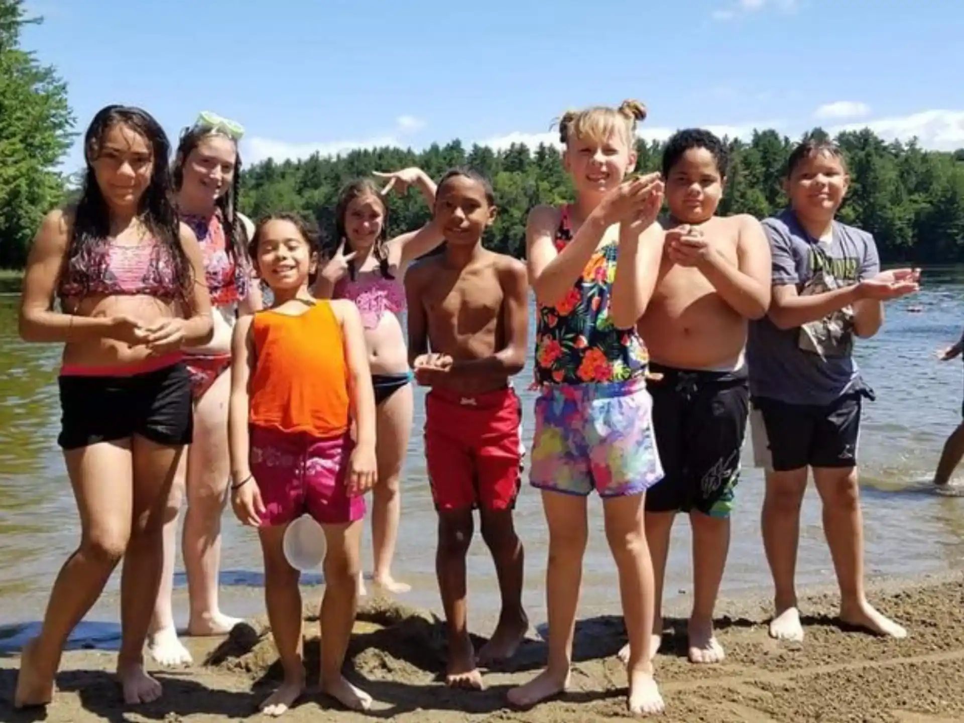 a group of people posing for a photo on a beach