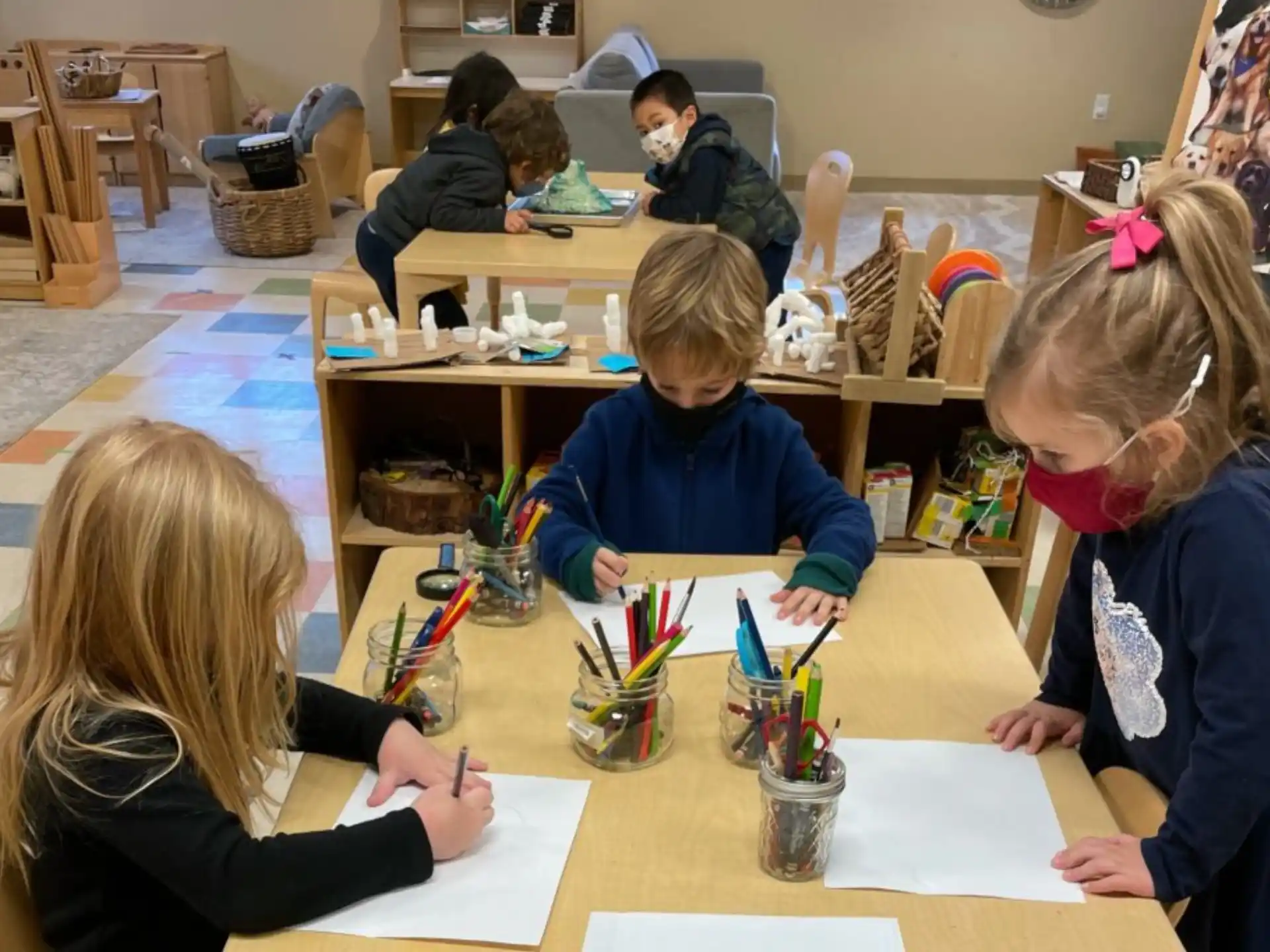a group of children sitting at a table