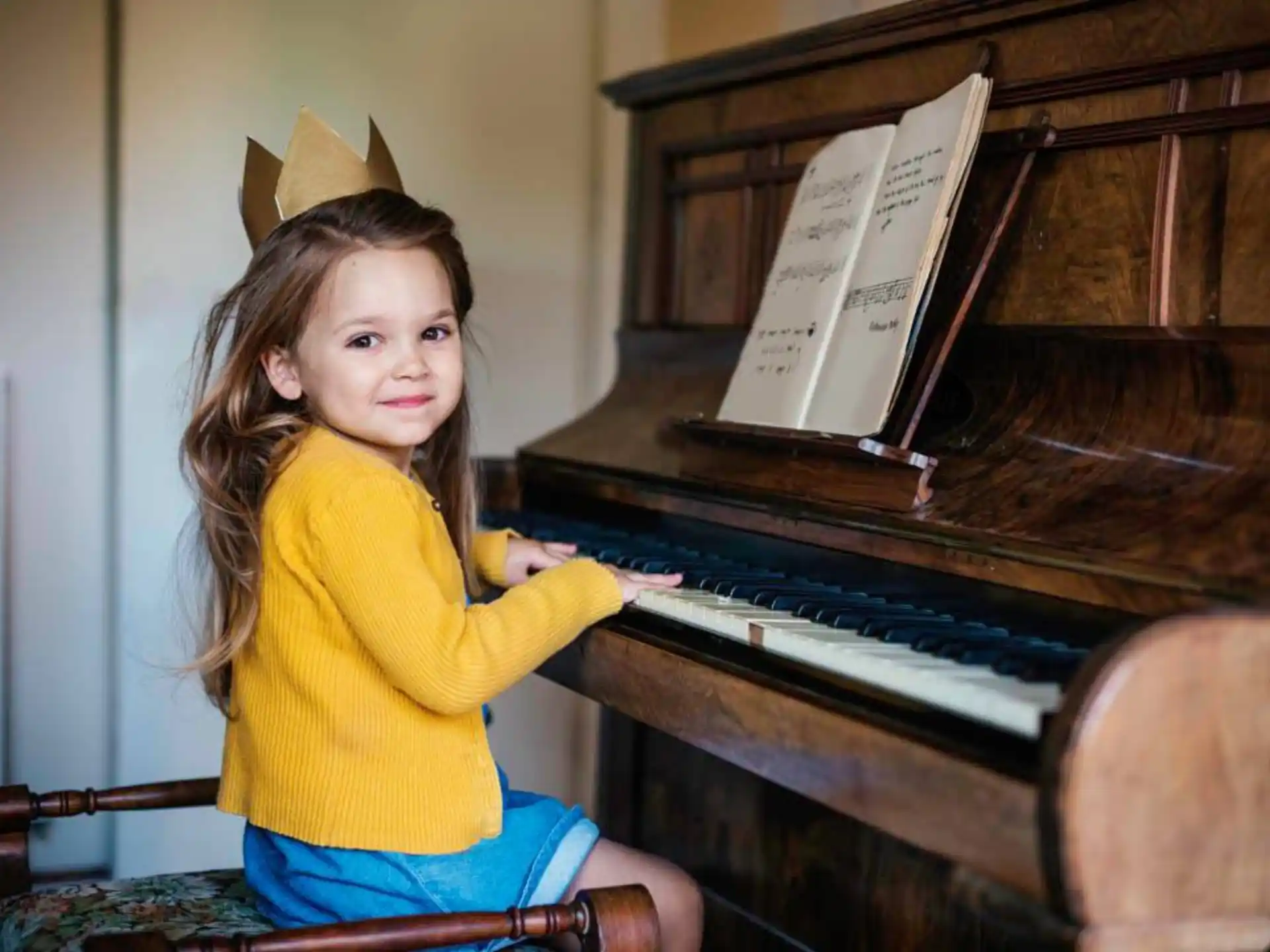 a girl sitting at a piano