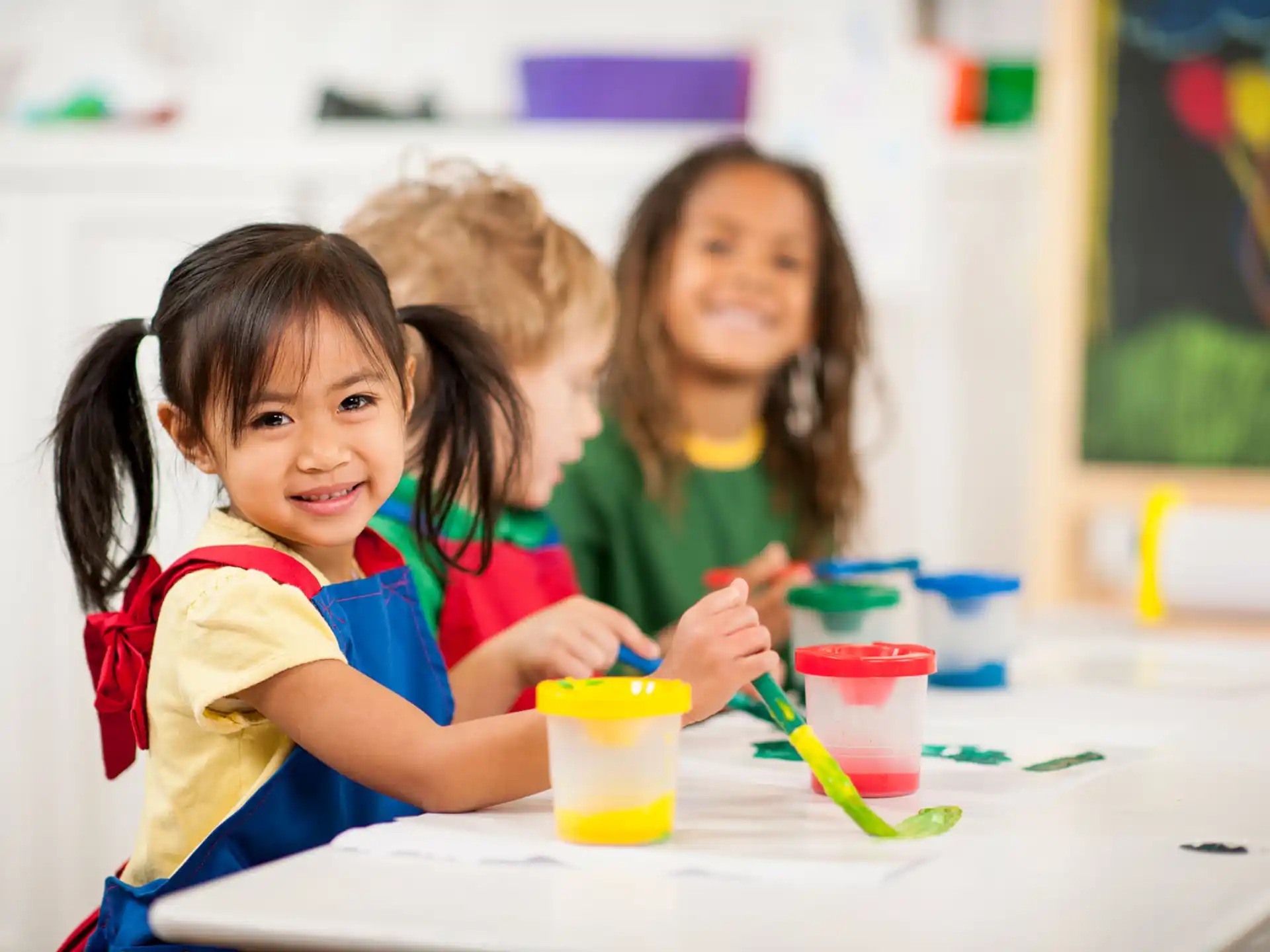 a group of children sitting at a table
