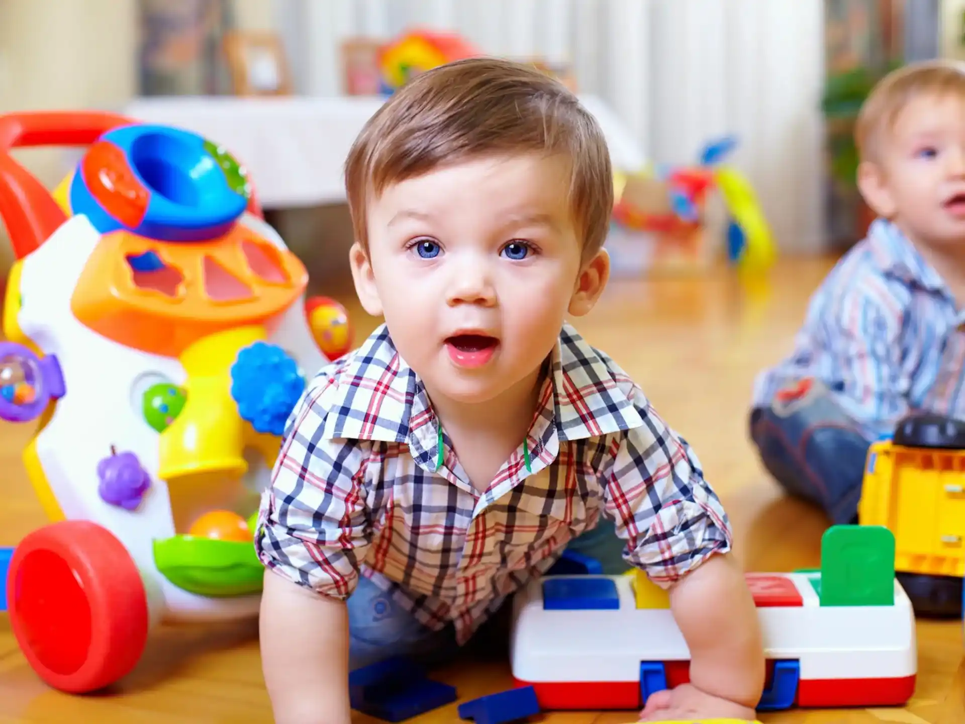 a couple of babies playing with toys