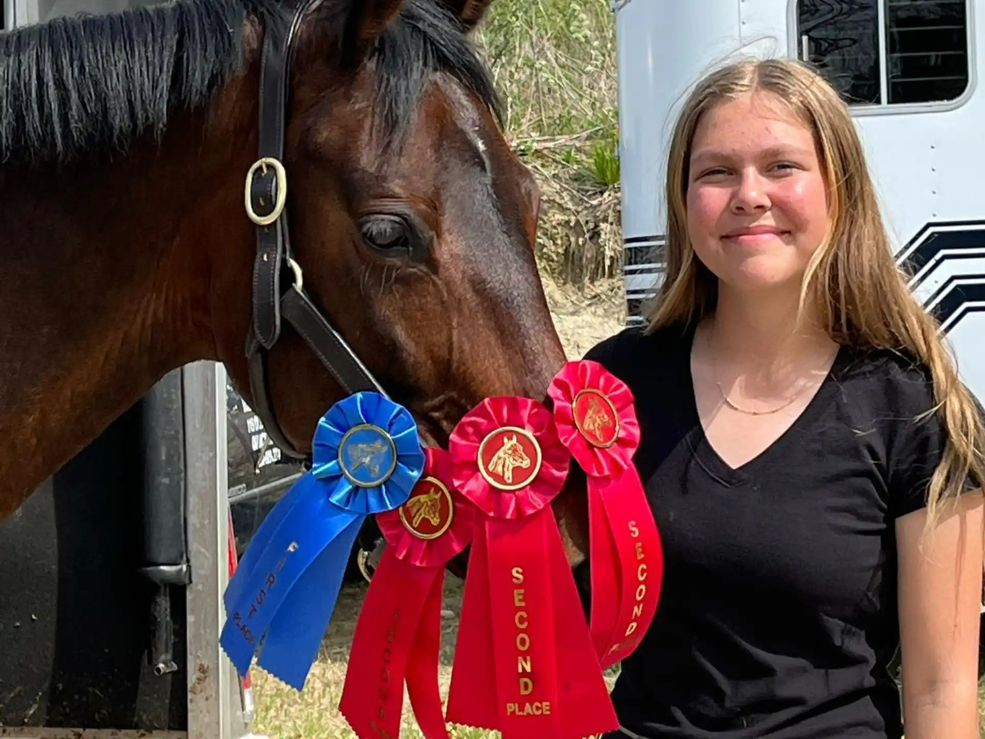 a woman standing next to a horse