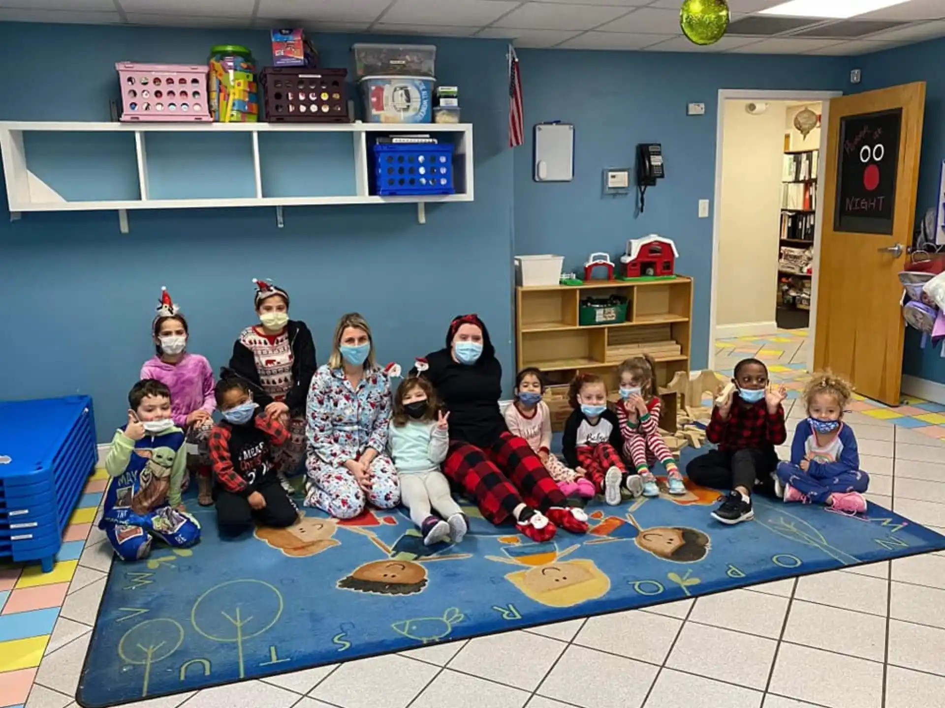 a group of children sitting on the floor in a room