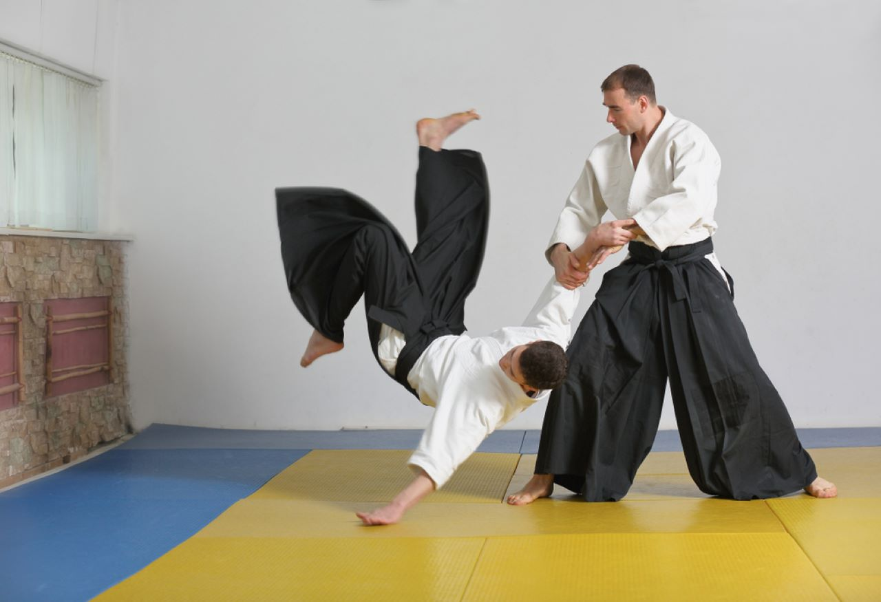 a man kicking another man in the face