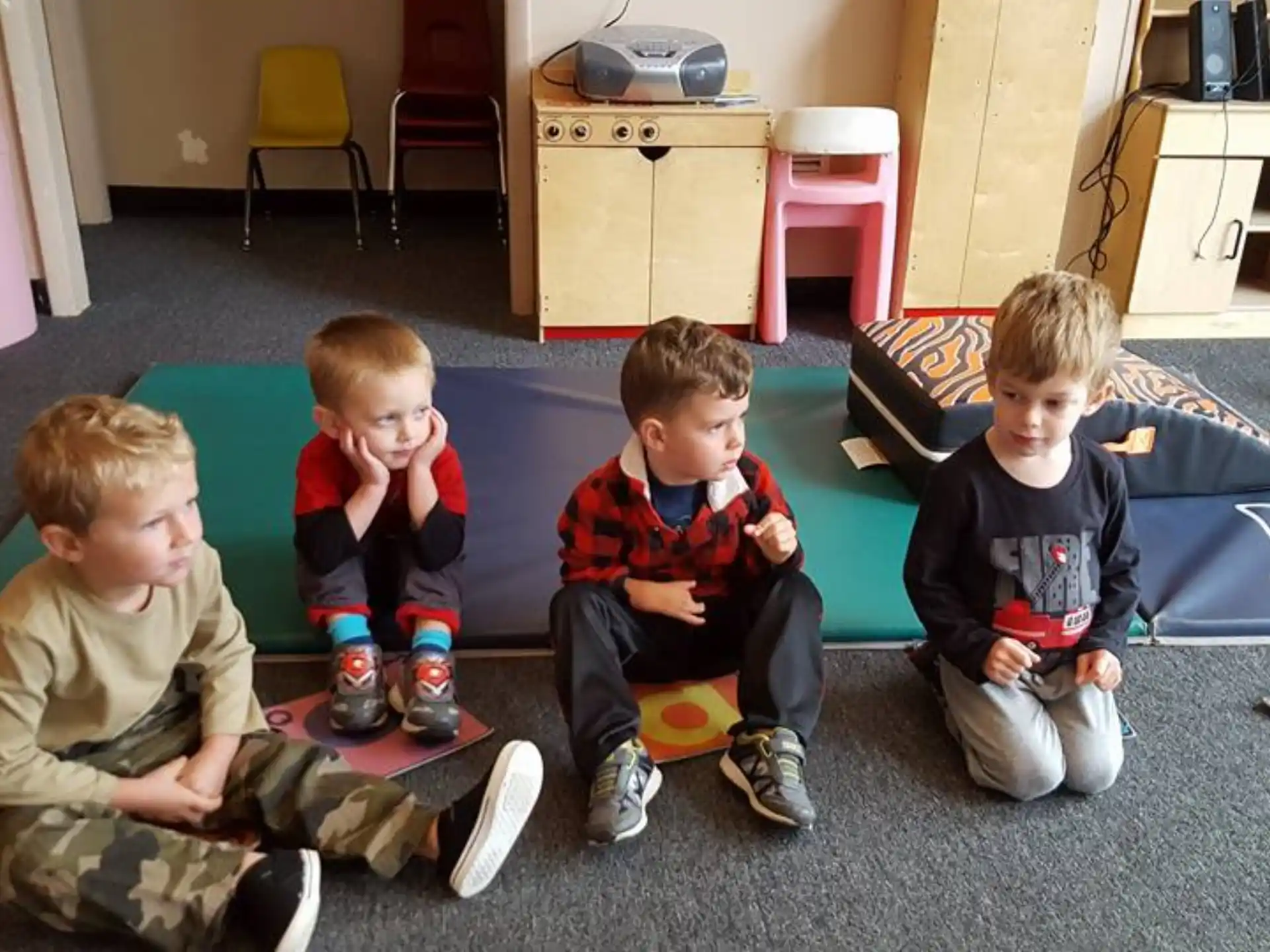 a group of boys sitting on the floor