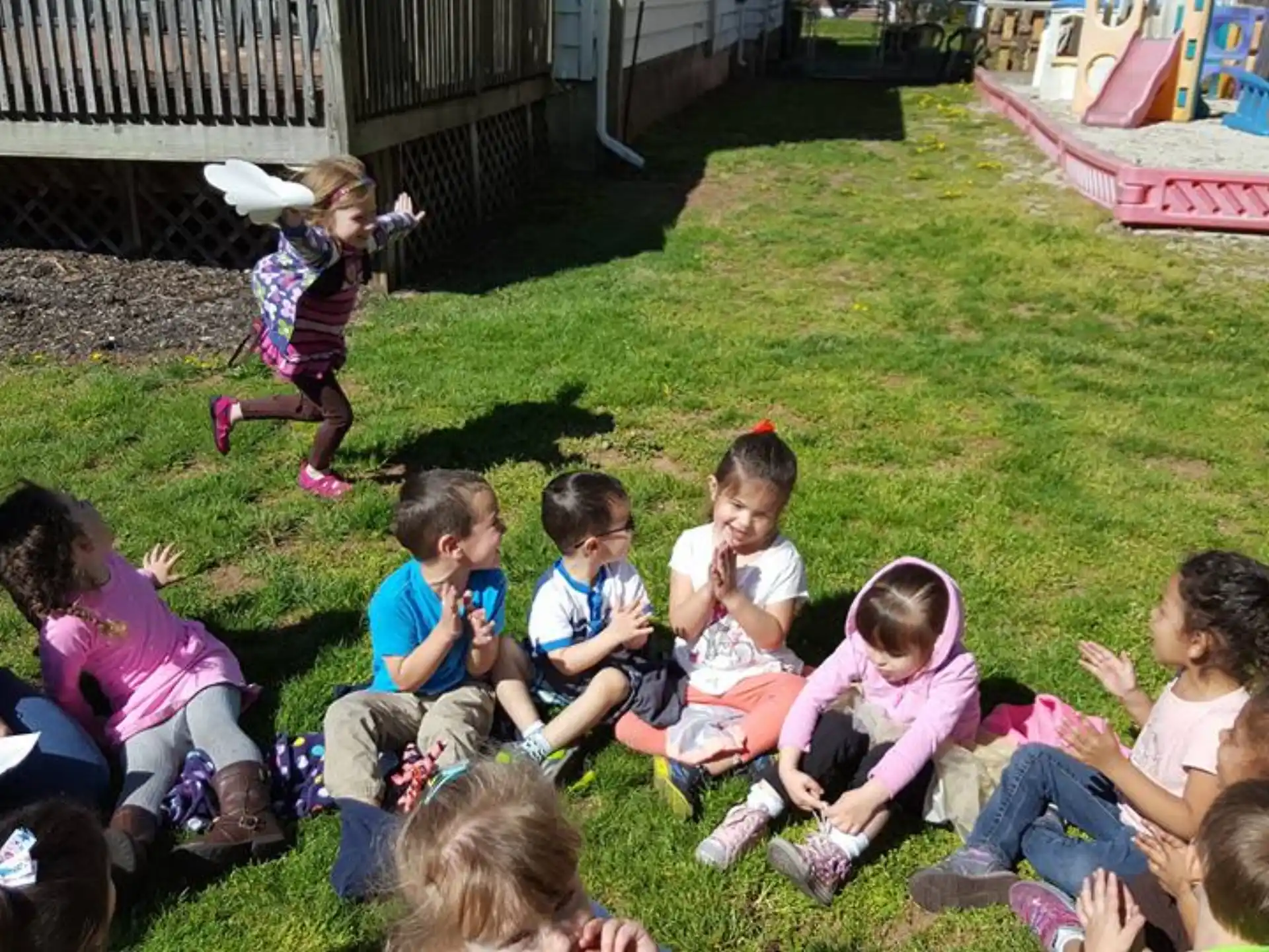 a group of children sitting on the grass