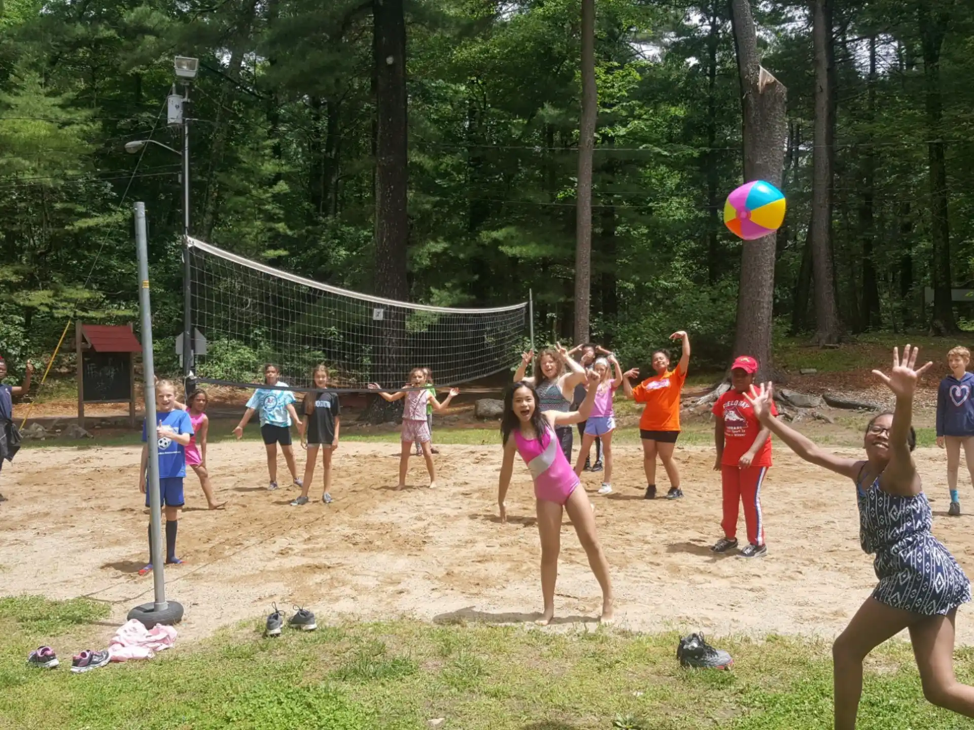 a group of people playing volleyball