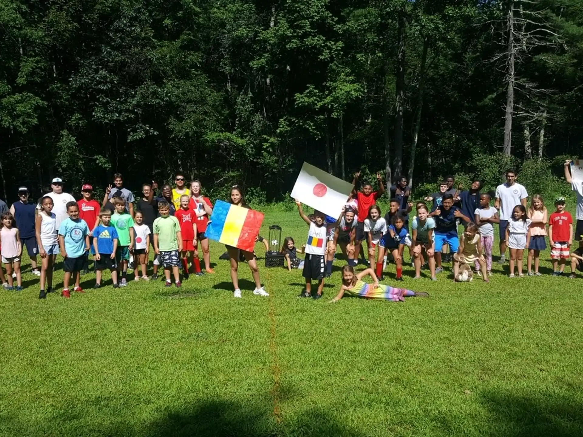 a group of people standing on grass