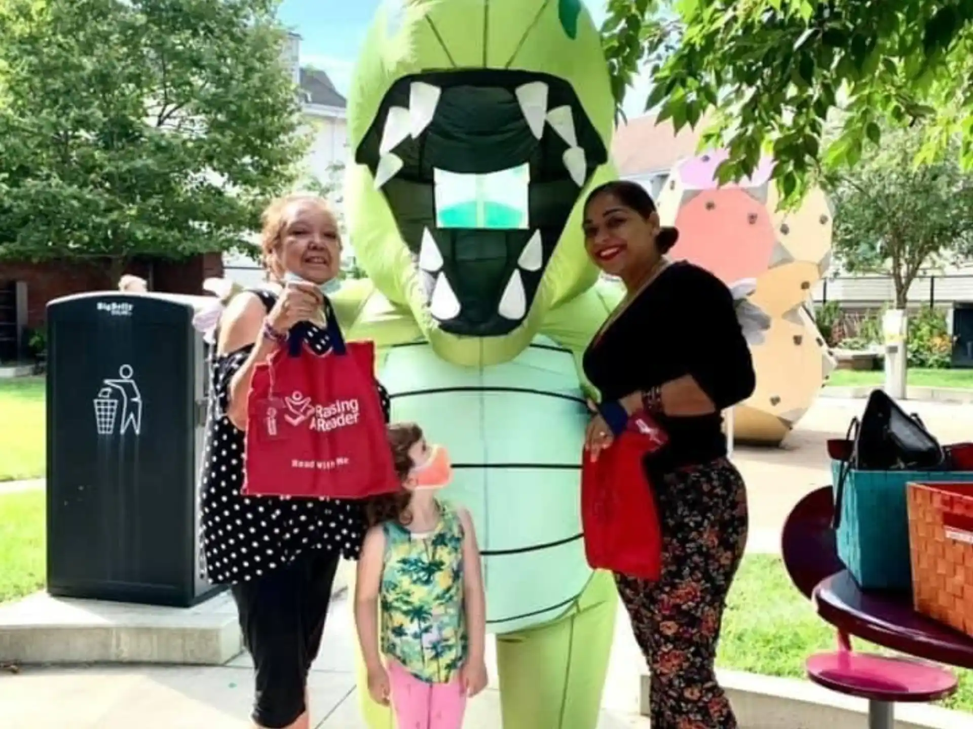 a group of people posing for a photo with a person in a garment