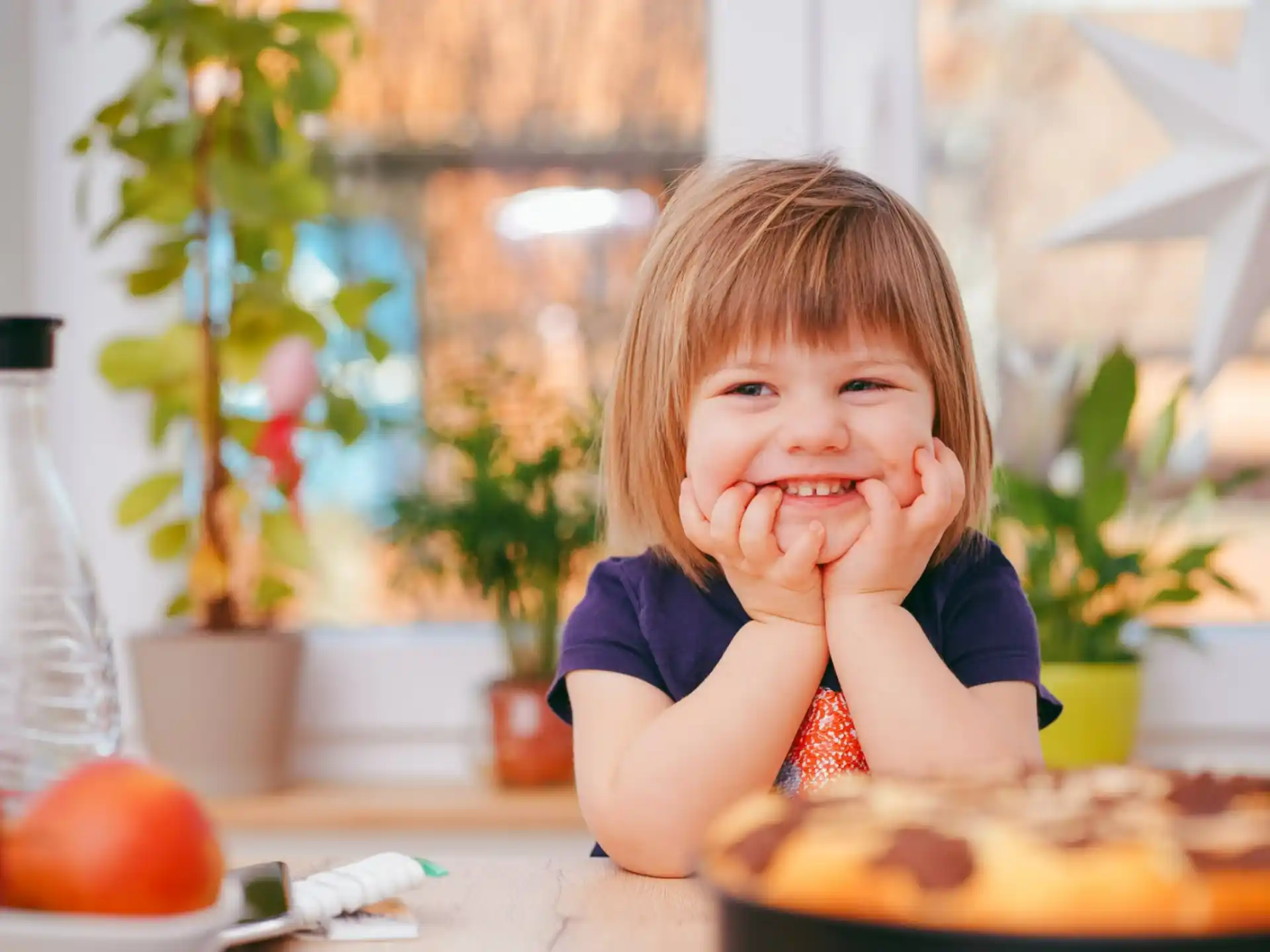 a little girl eating a cake