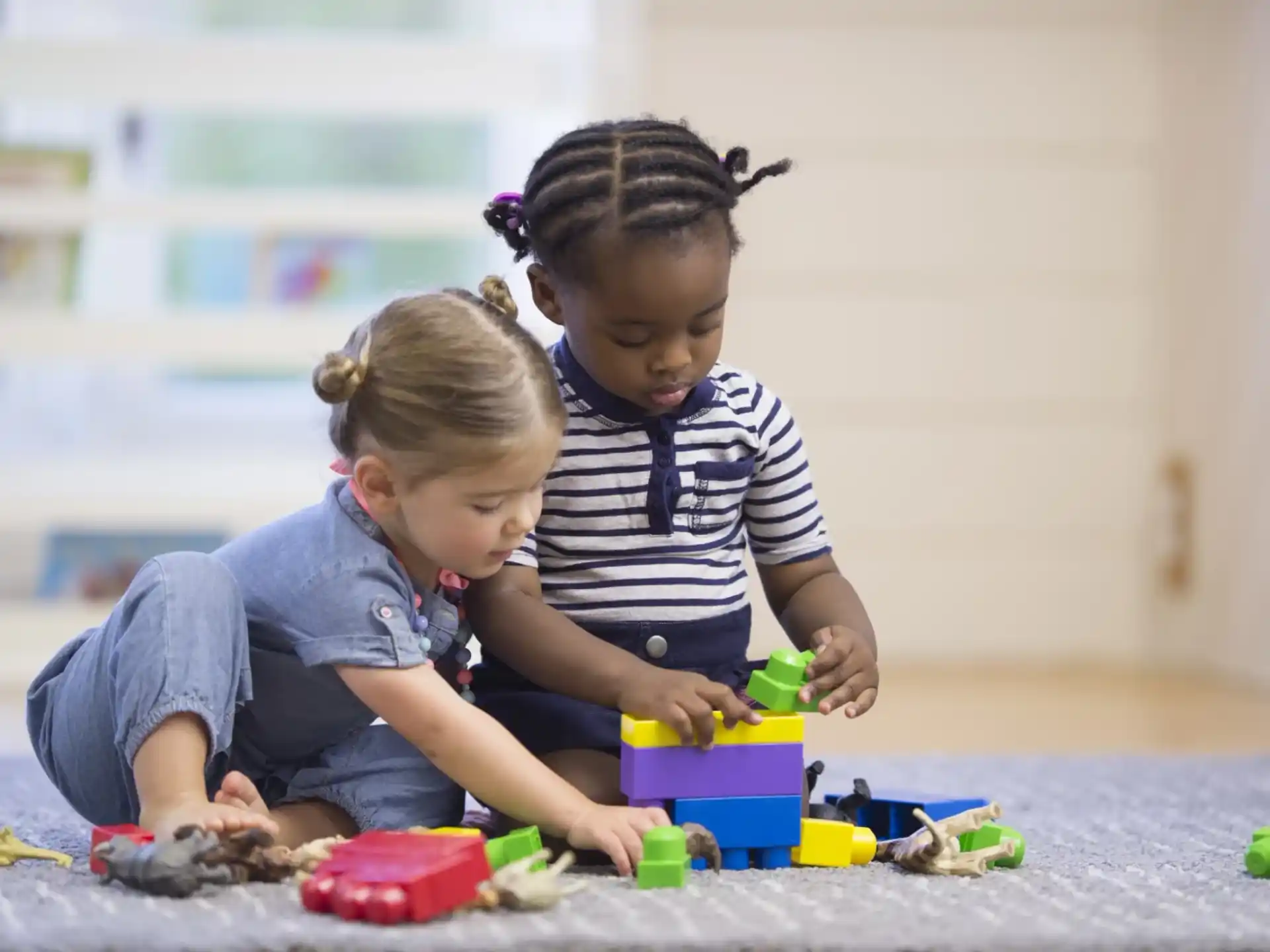 a couple of children playing with toys