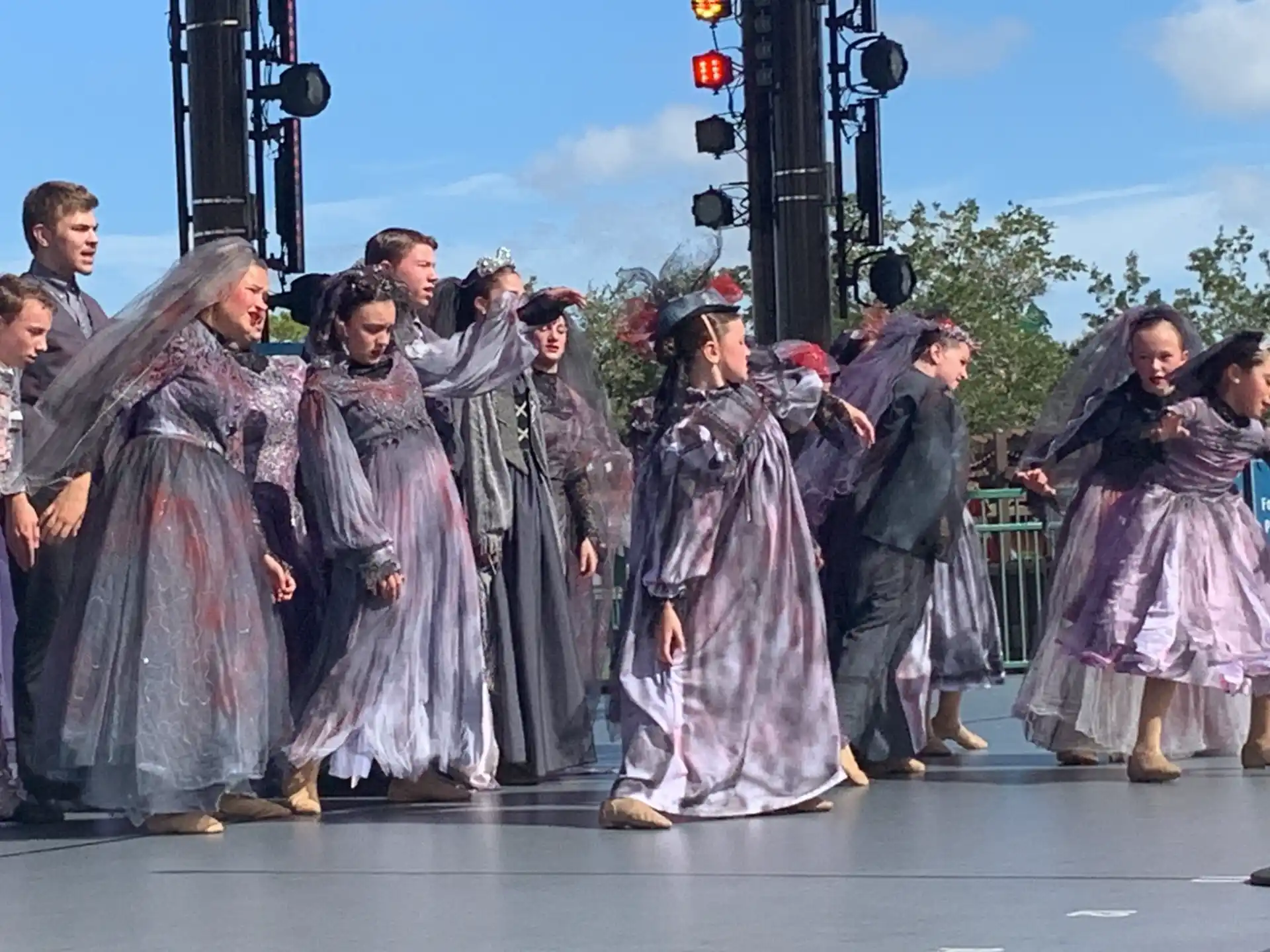 a group of people in robes and hats on a stage