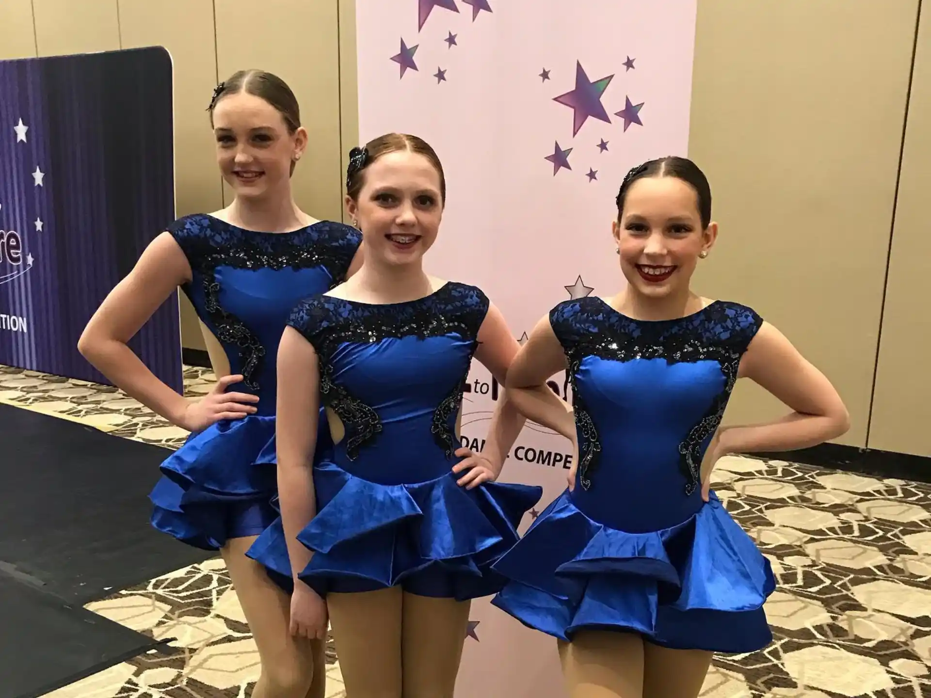 a group of girls in blue dresses