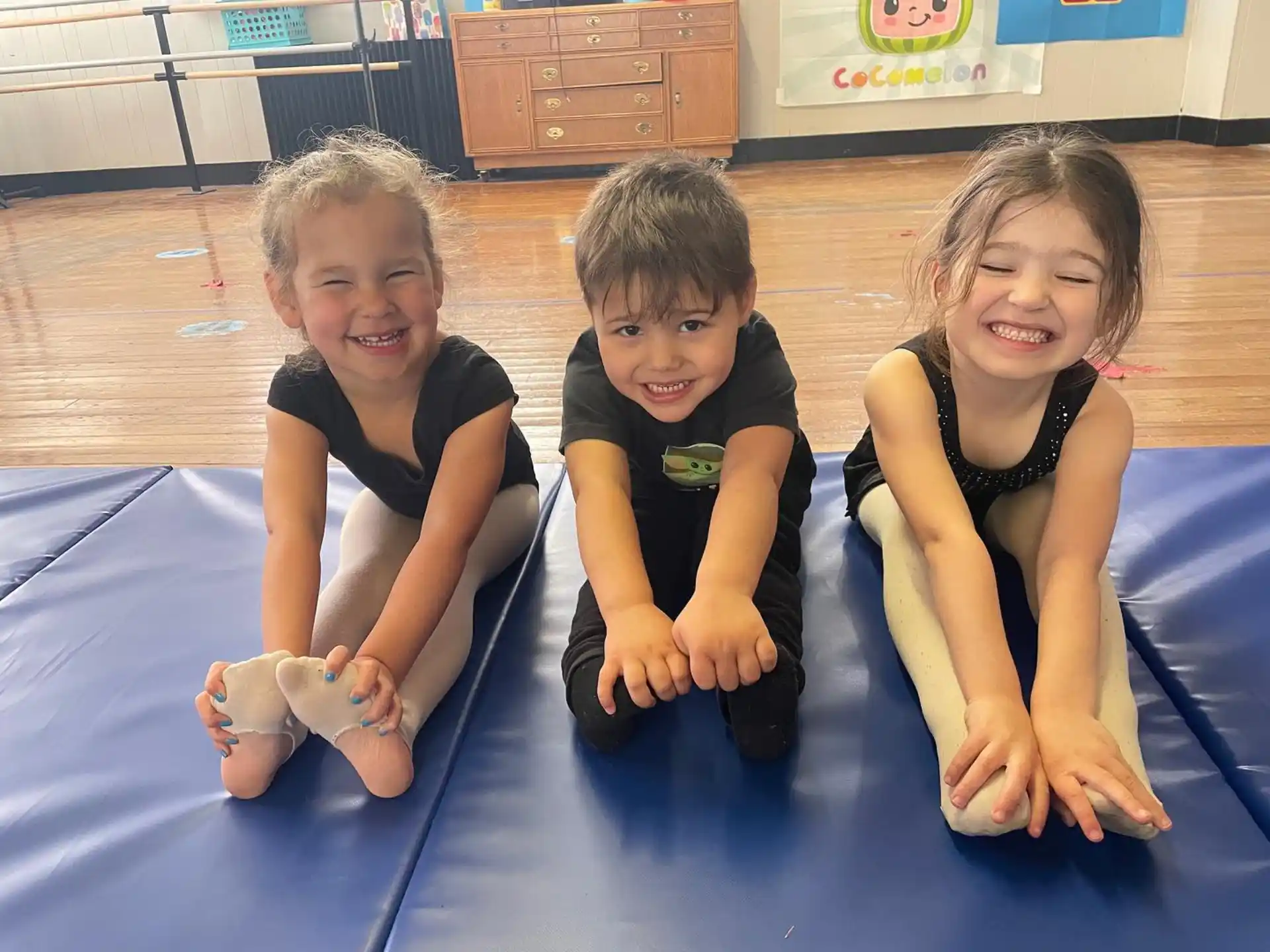 a group of children sitting on a mat