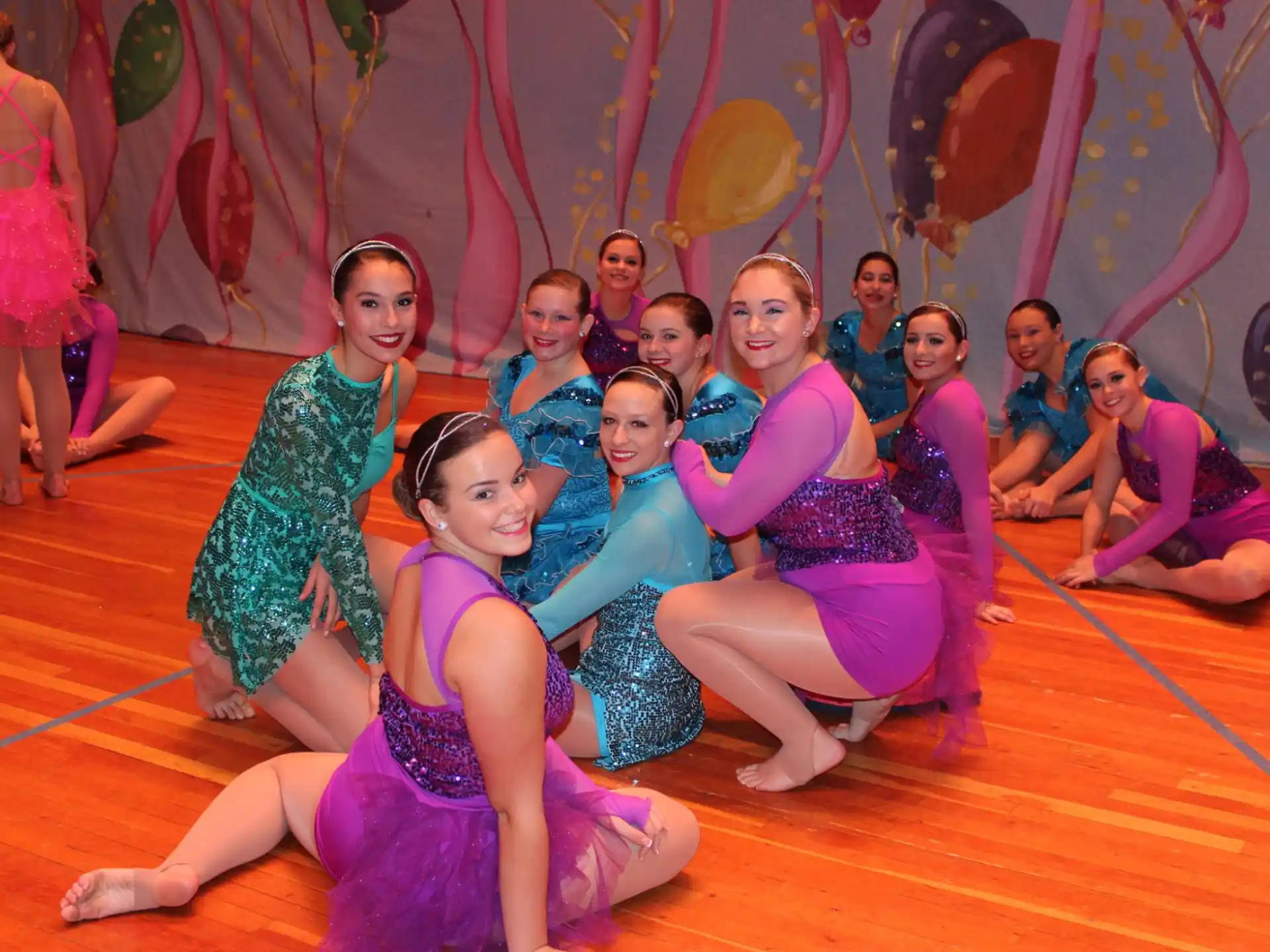 a group of women in colorful dresses