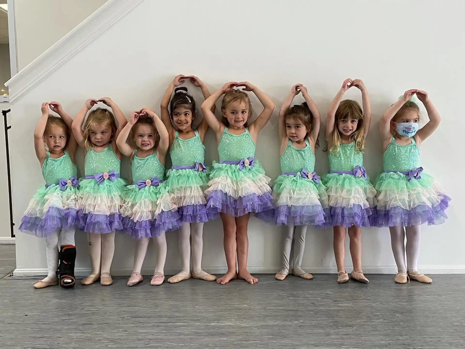 a group of girls in dresses