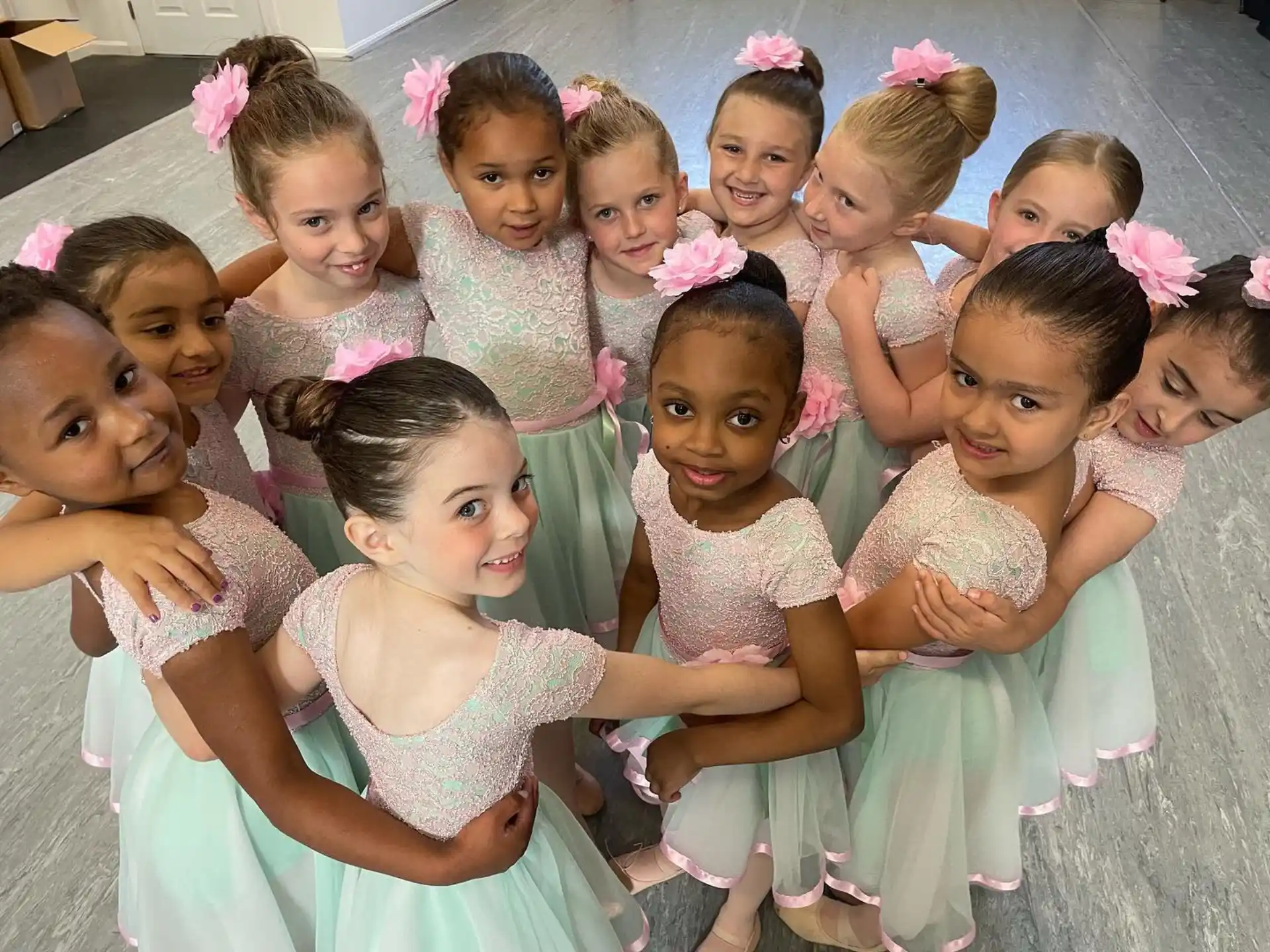 a group of girls in dresses