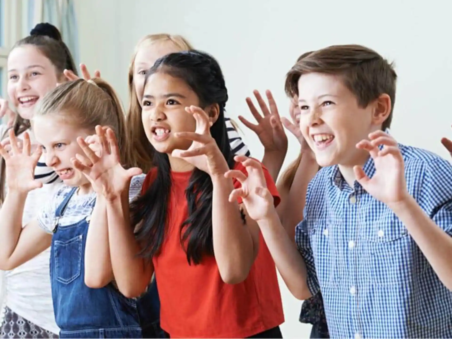 a group of people holding their hands up