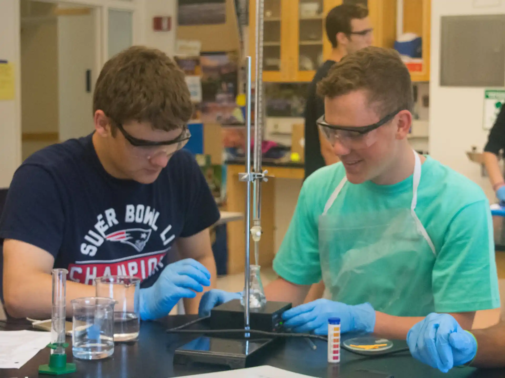 a couple of men wearing gloves and gloves working at a table