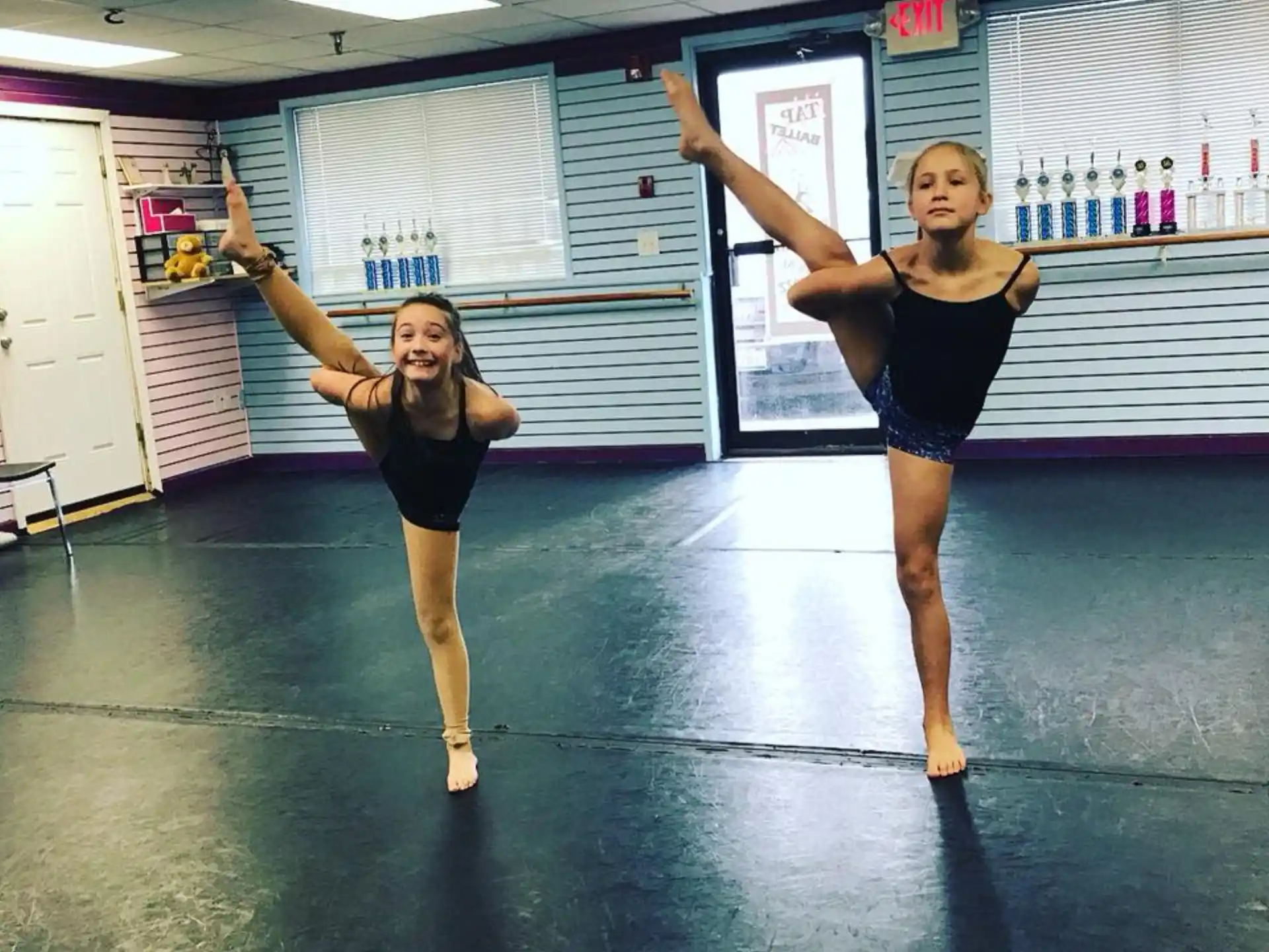 two women dancing in a gym