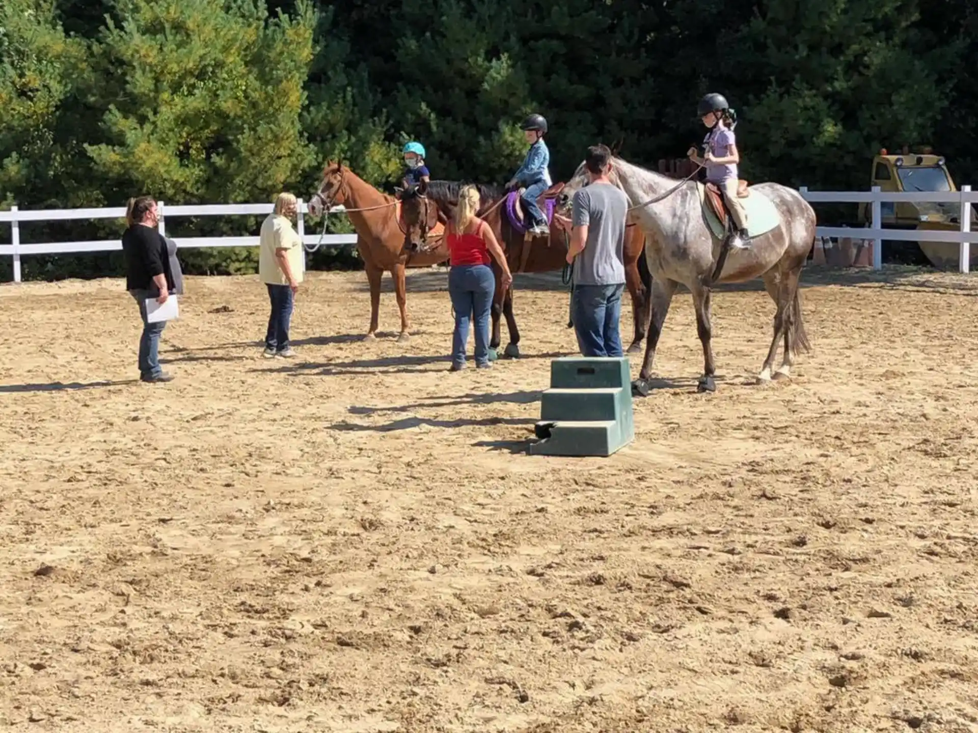 people riding horses in a field