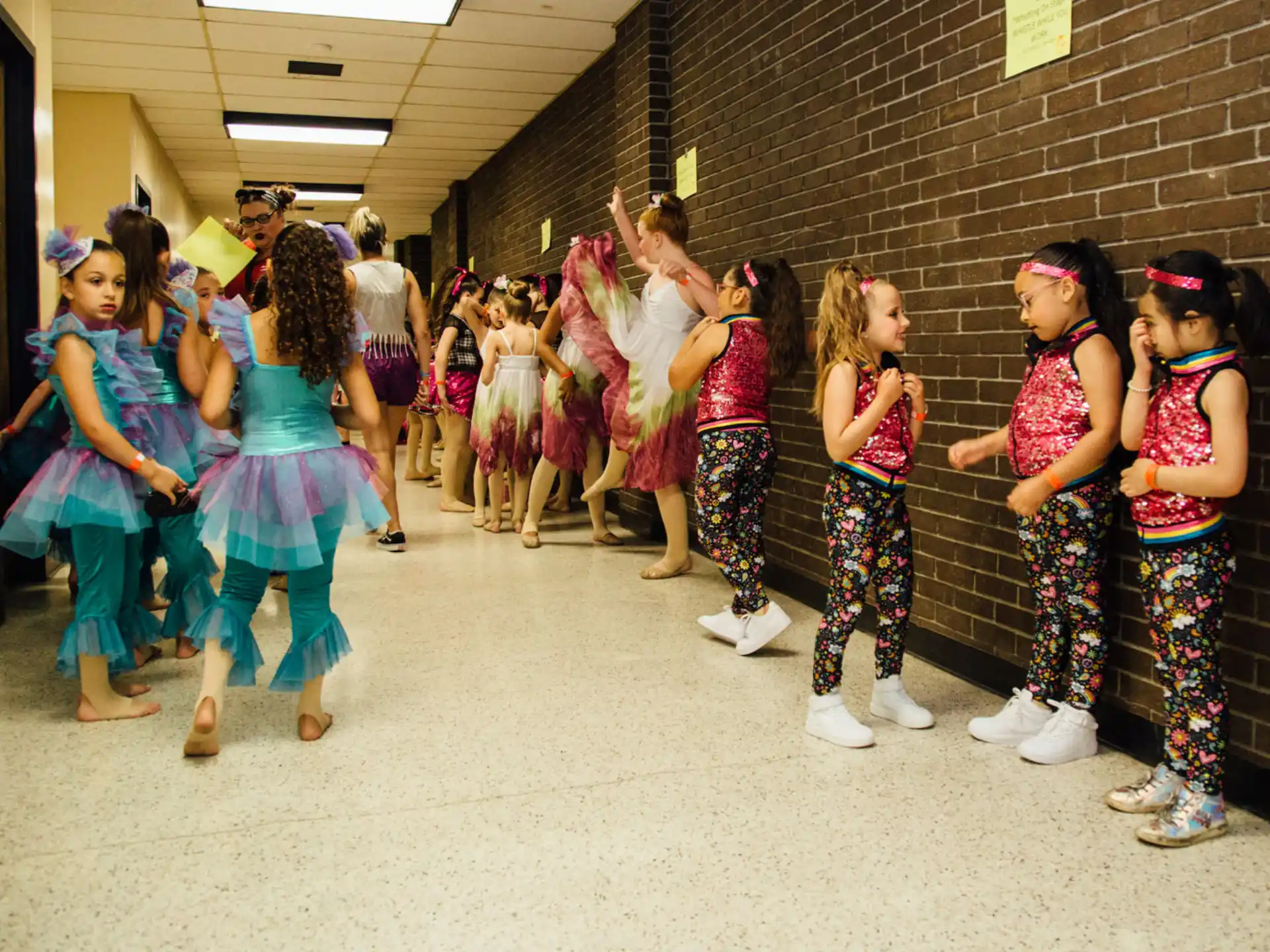 a group of girls in colorful dresses