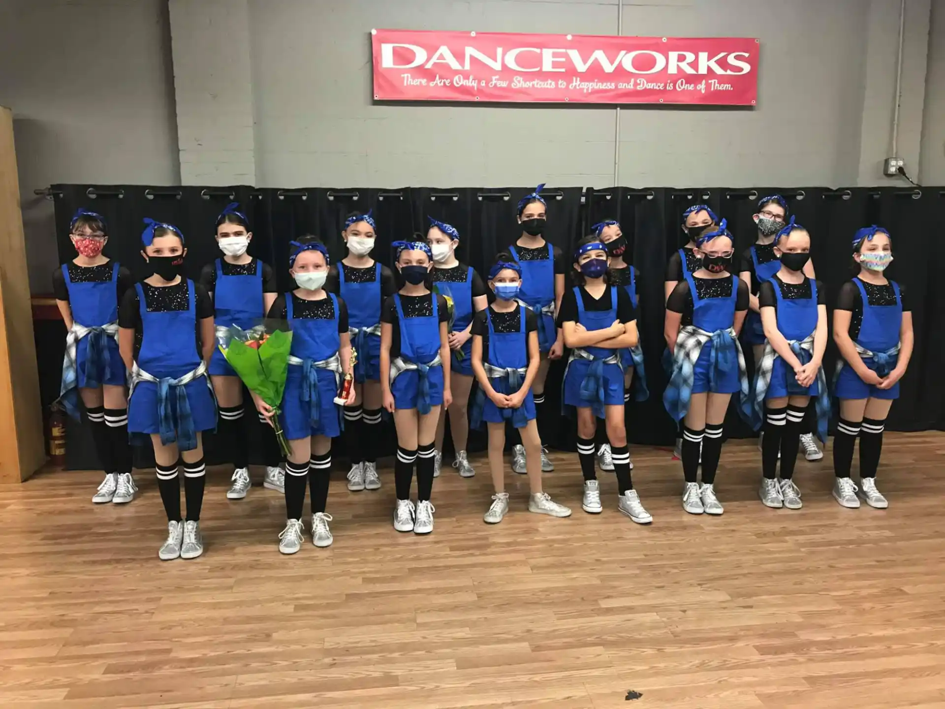 a group of cheerleaders in blue uniforms