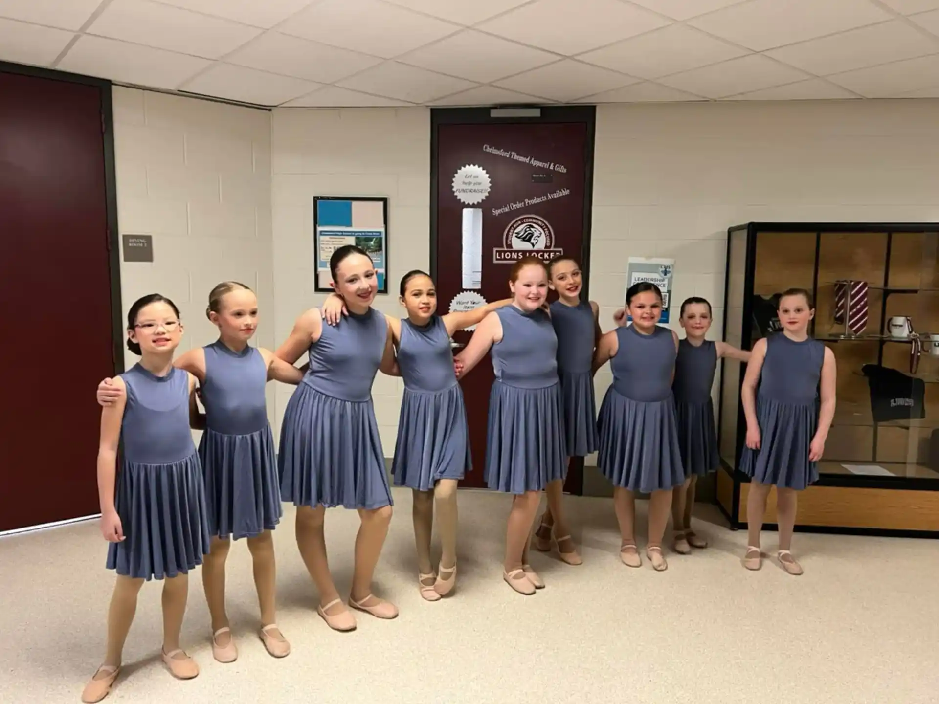 a group of girls in blue dresses