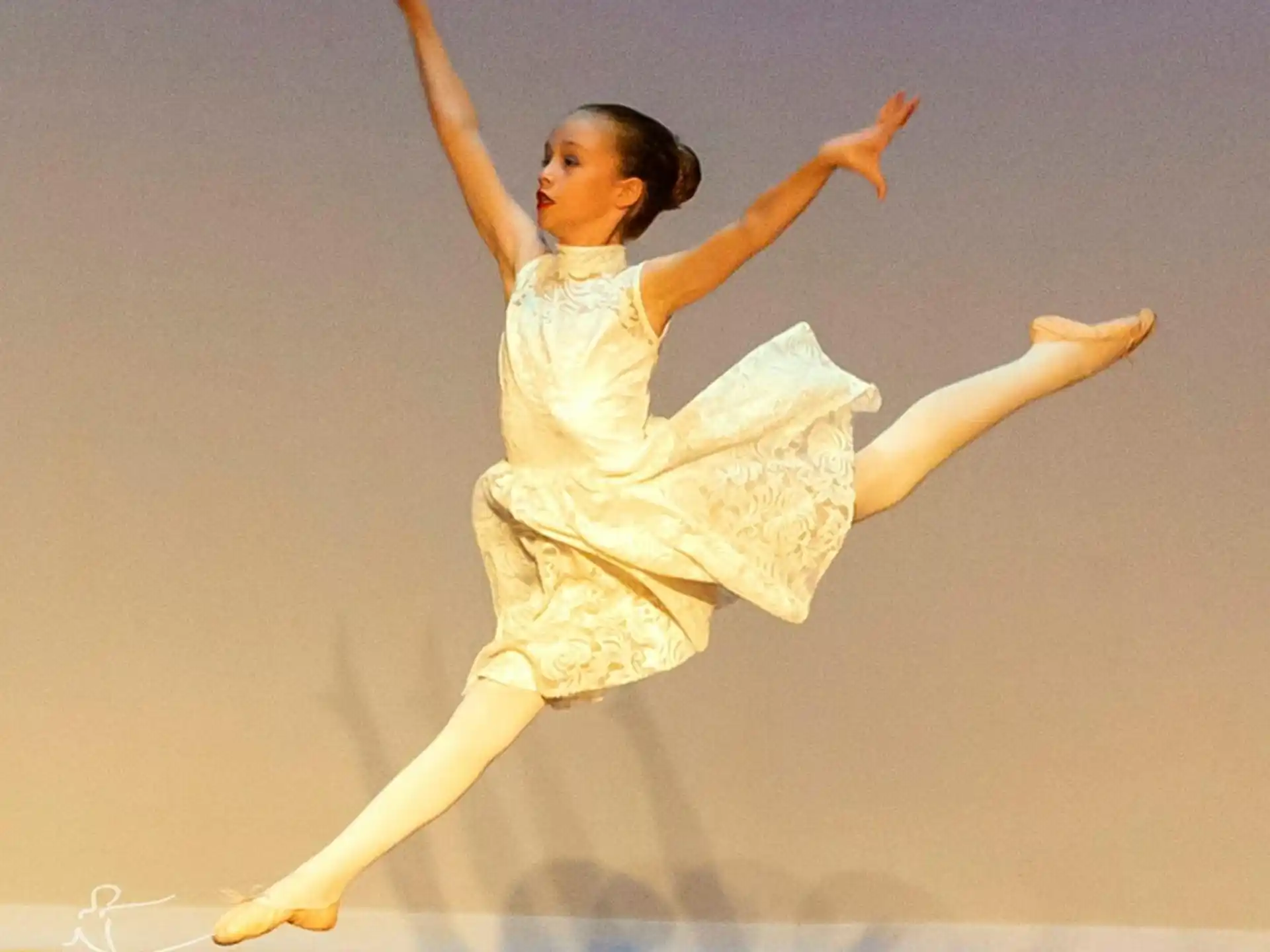 a woman in a white dress dancing