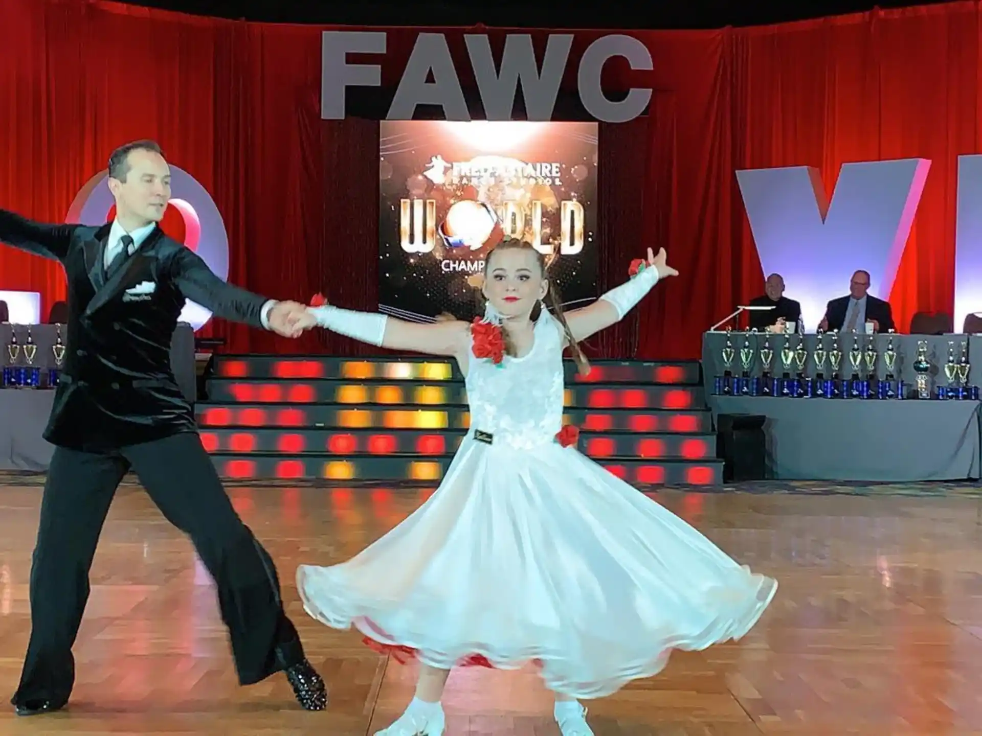 a man and woman dancing on a stage