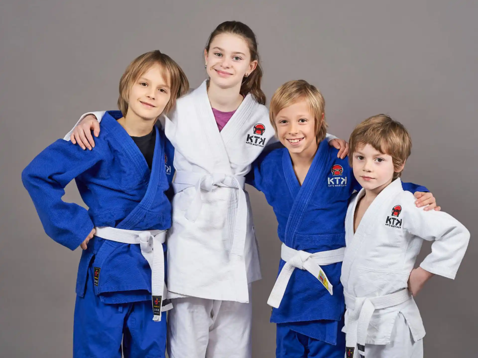 a group of girls in karate uniforms
