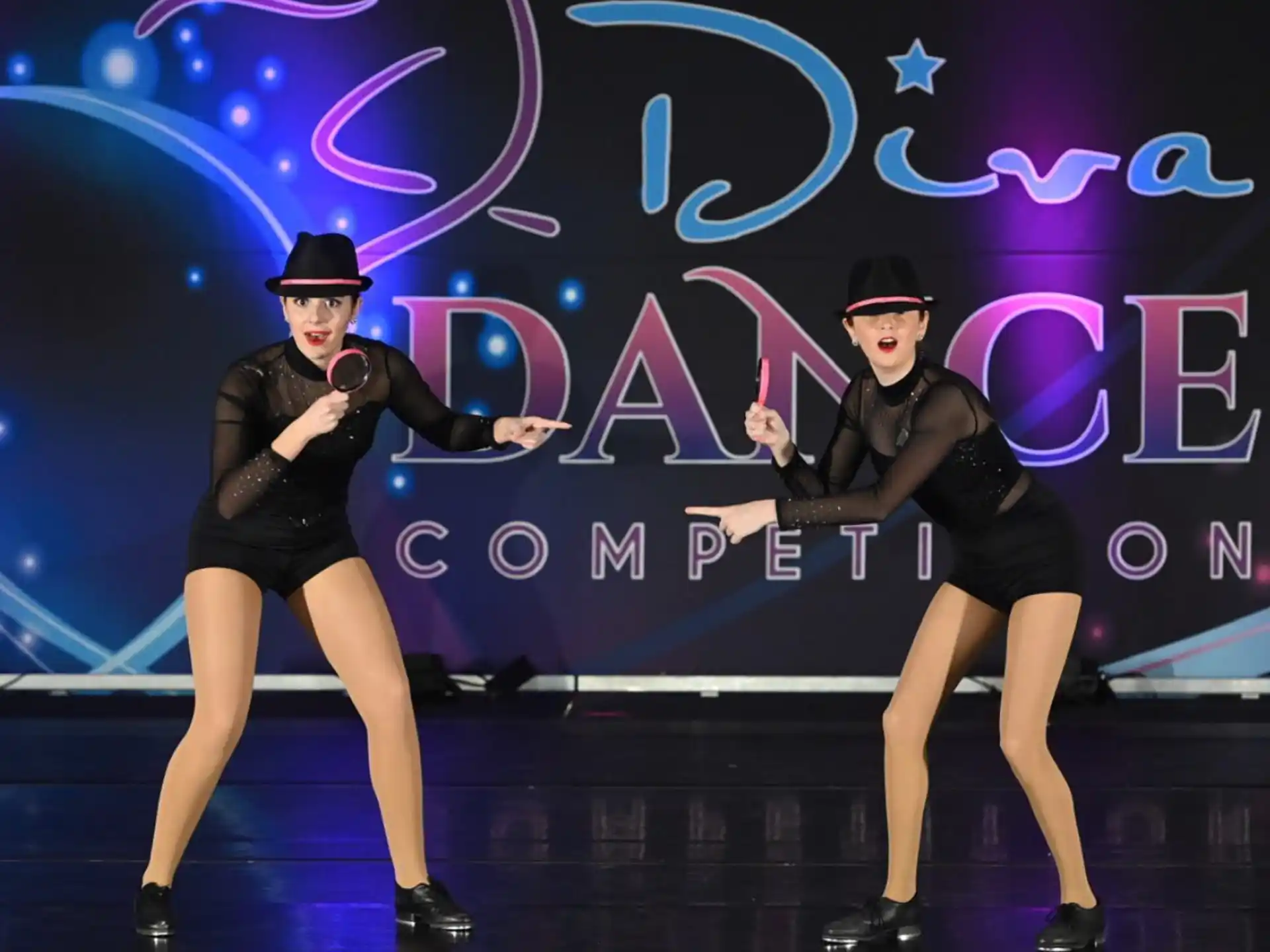a couple of women dancing on a stage