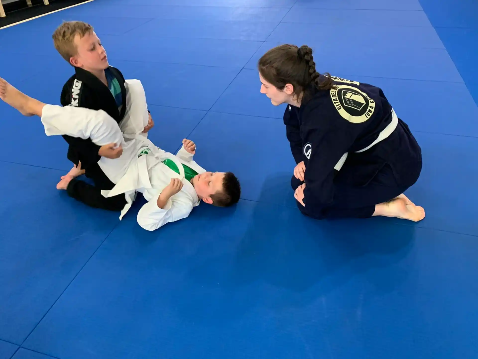 a group of children in karate uniforms