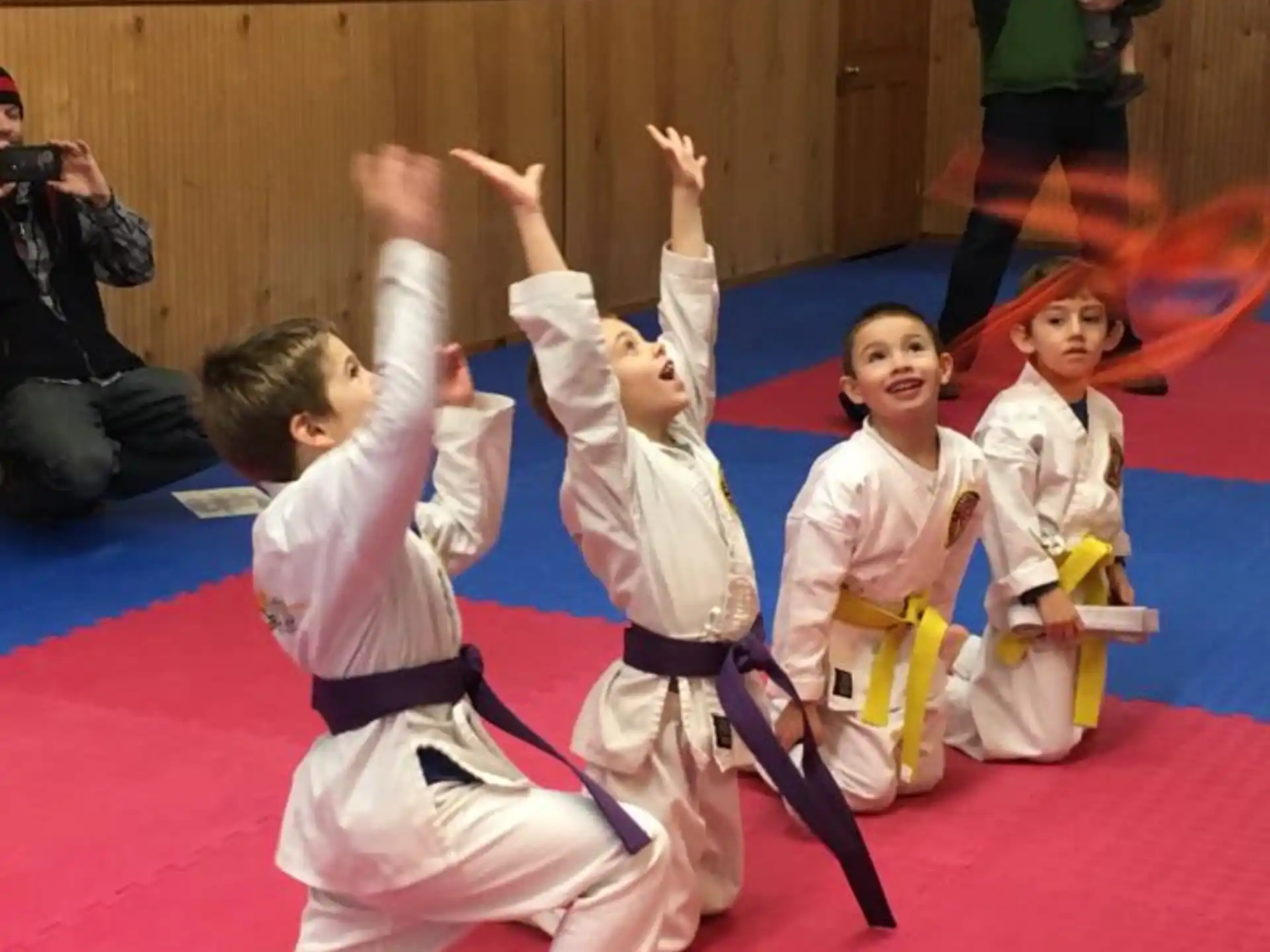 a group of children in karate uniforms