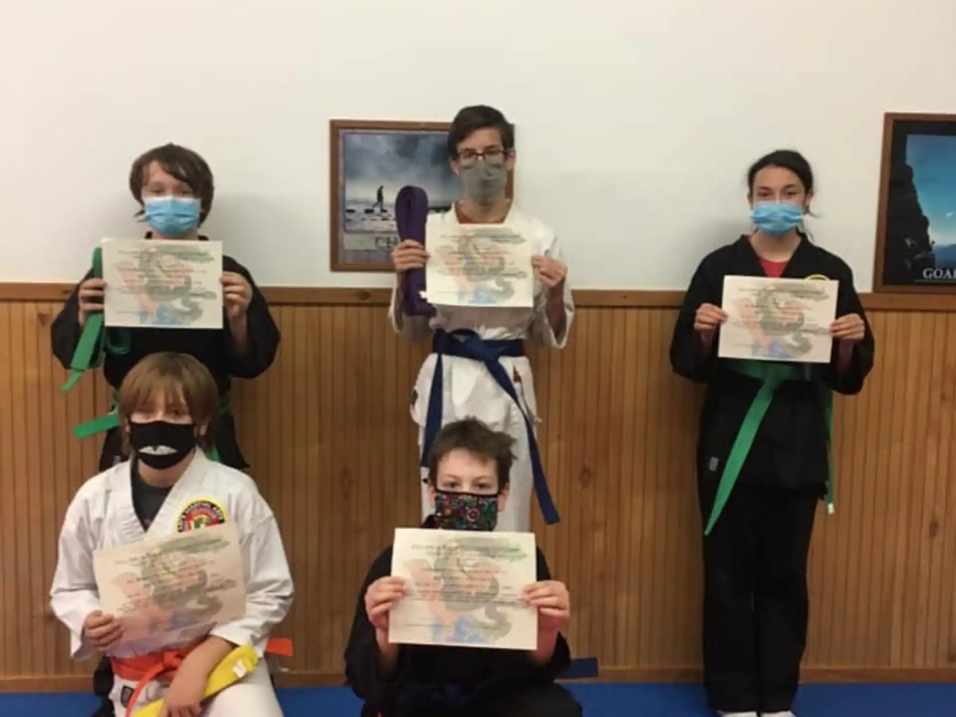 a group of people holding certificates