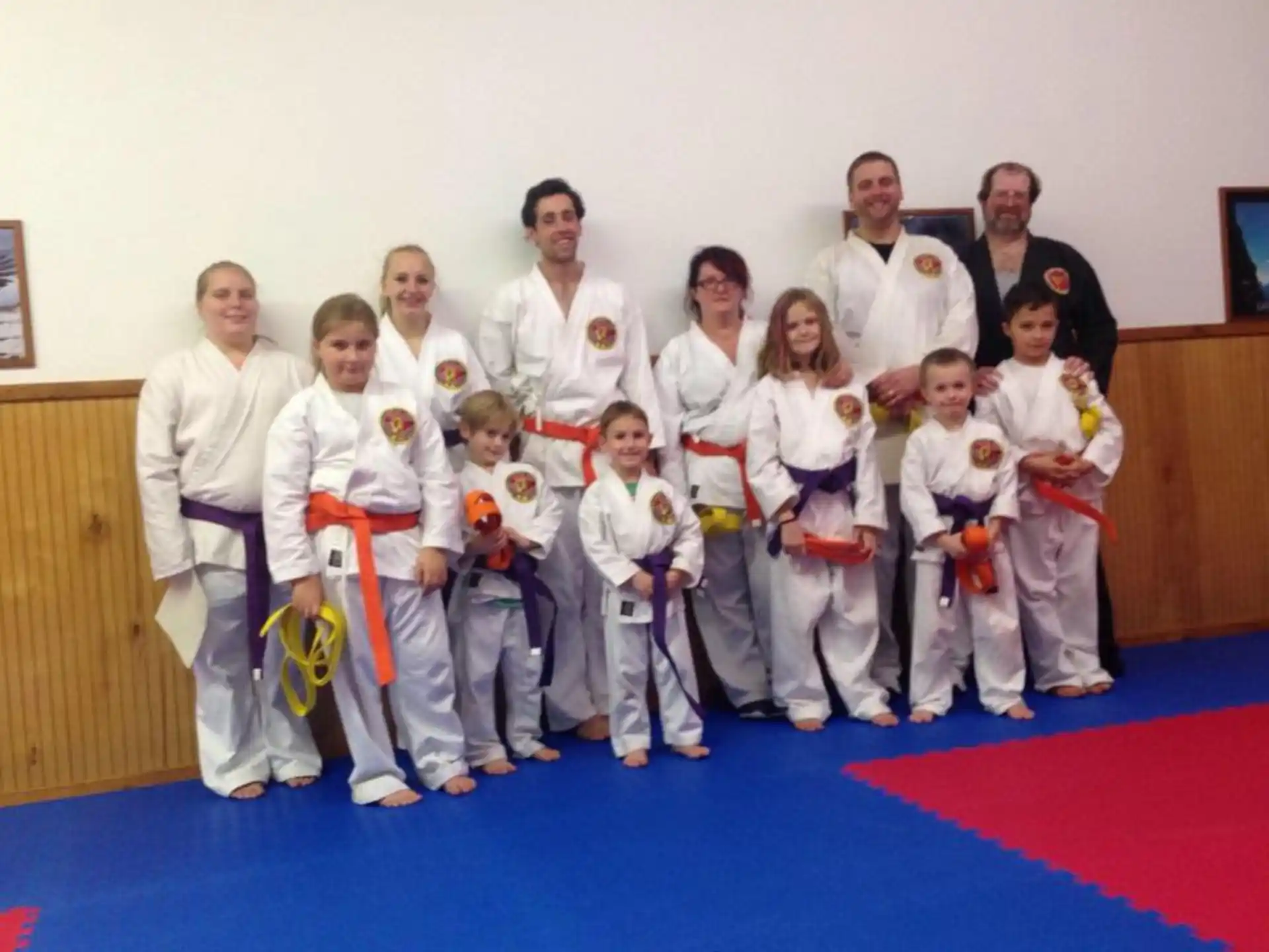 a group of people in karate uniforms