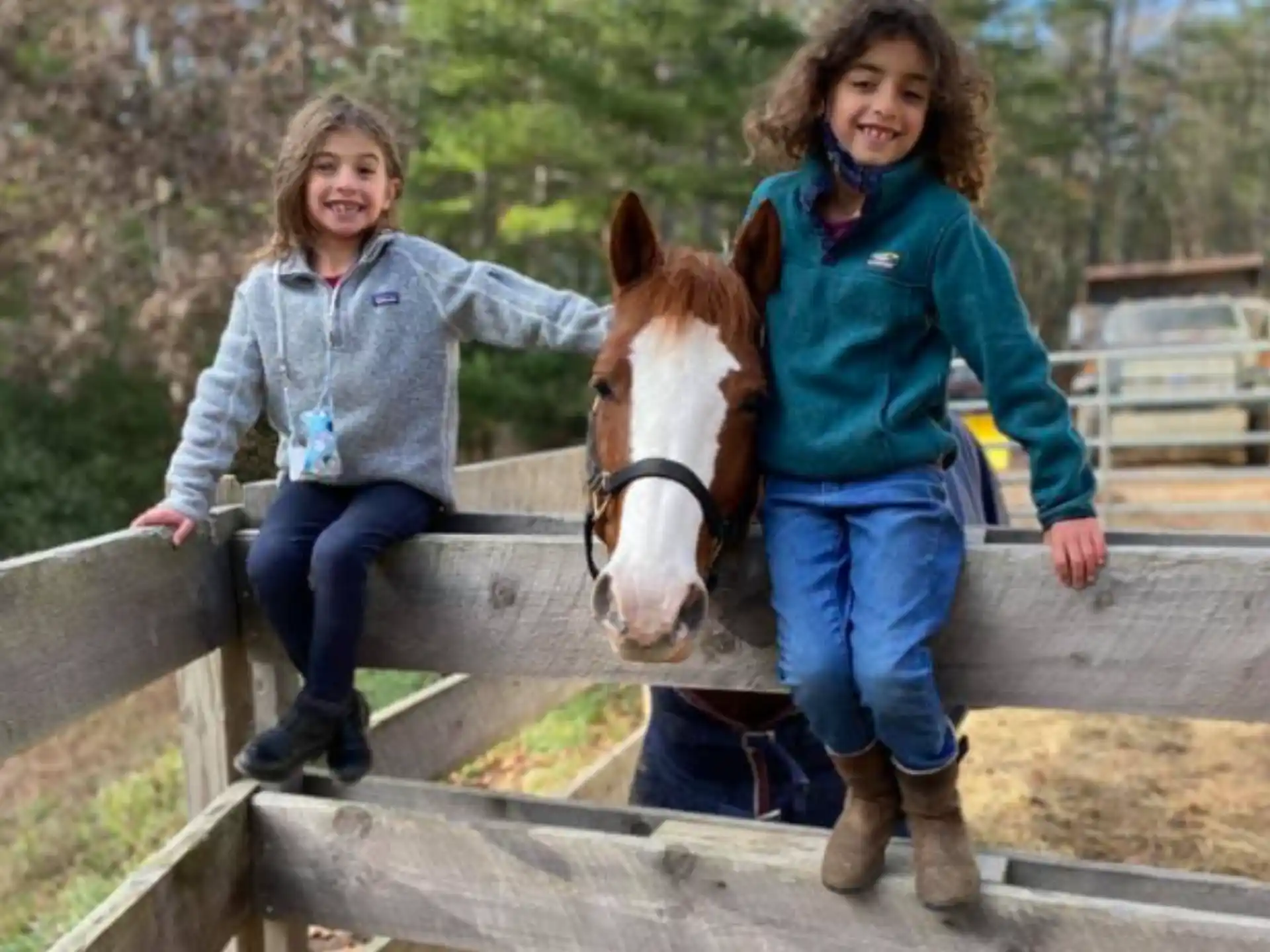 a couple of girls riding a horse