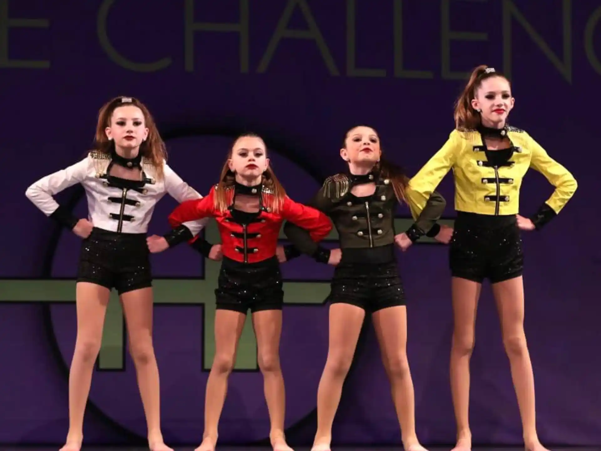 a group of girls in matching outfits