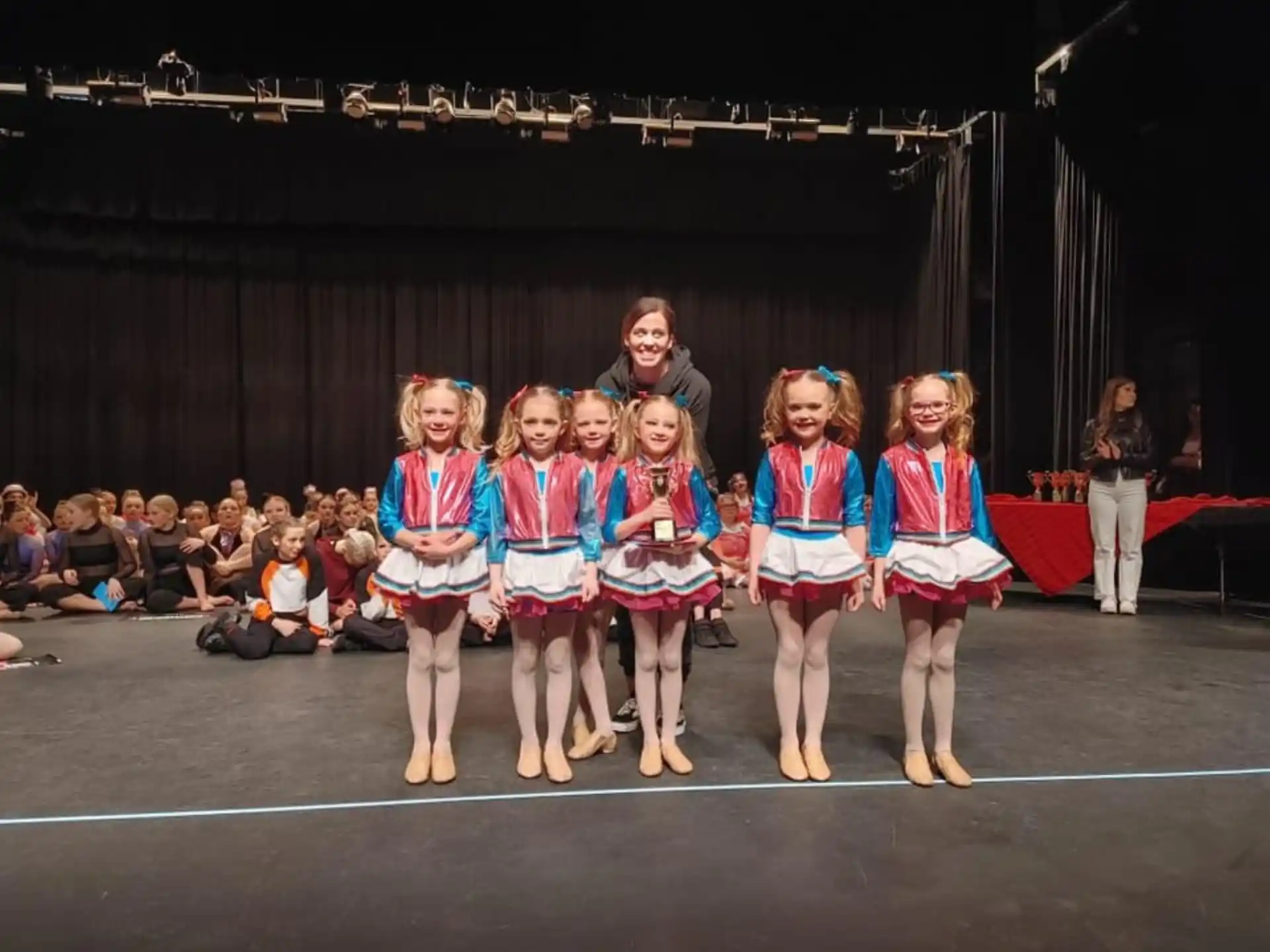a group of girls in matching outfits