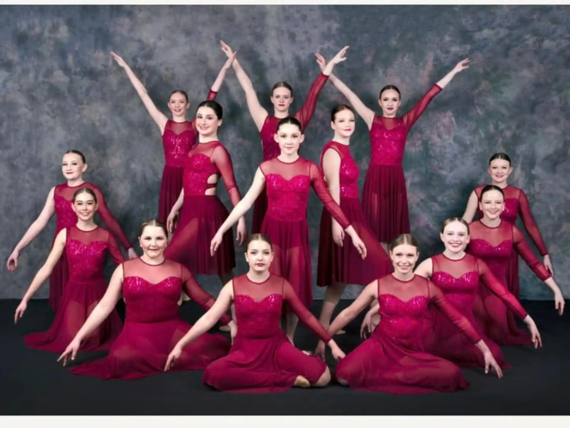 a group of women in red dresses