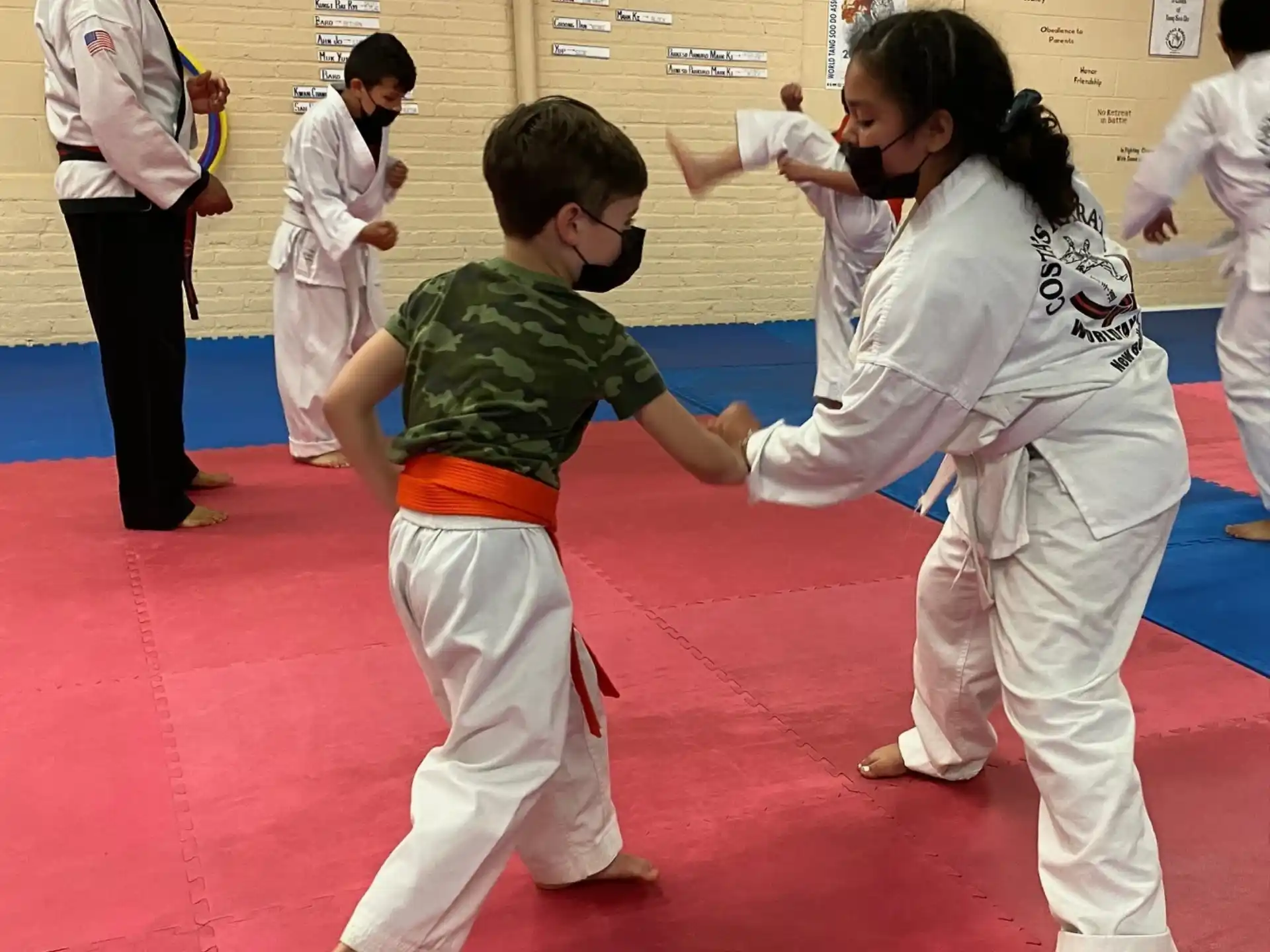 a group of children in karate uniforms