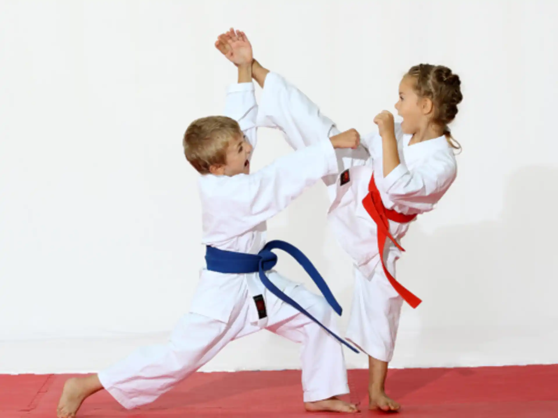 a boy and a girl in karate uniforms