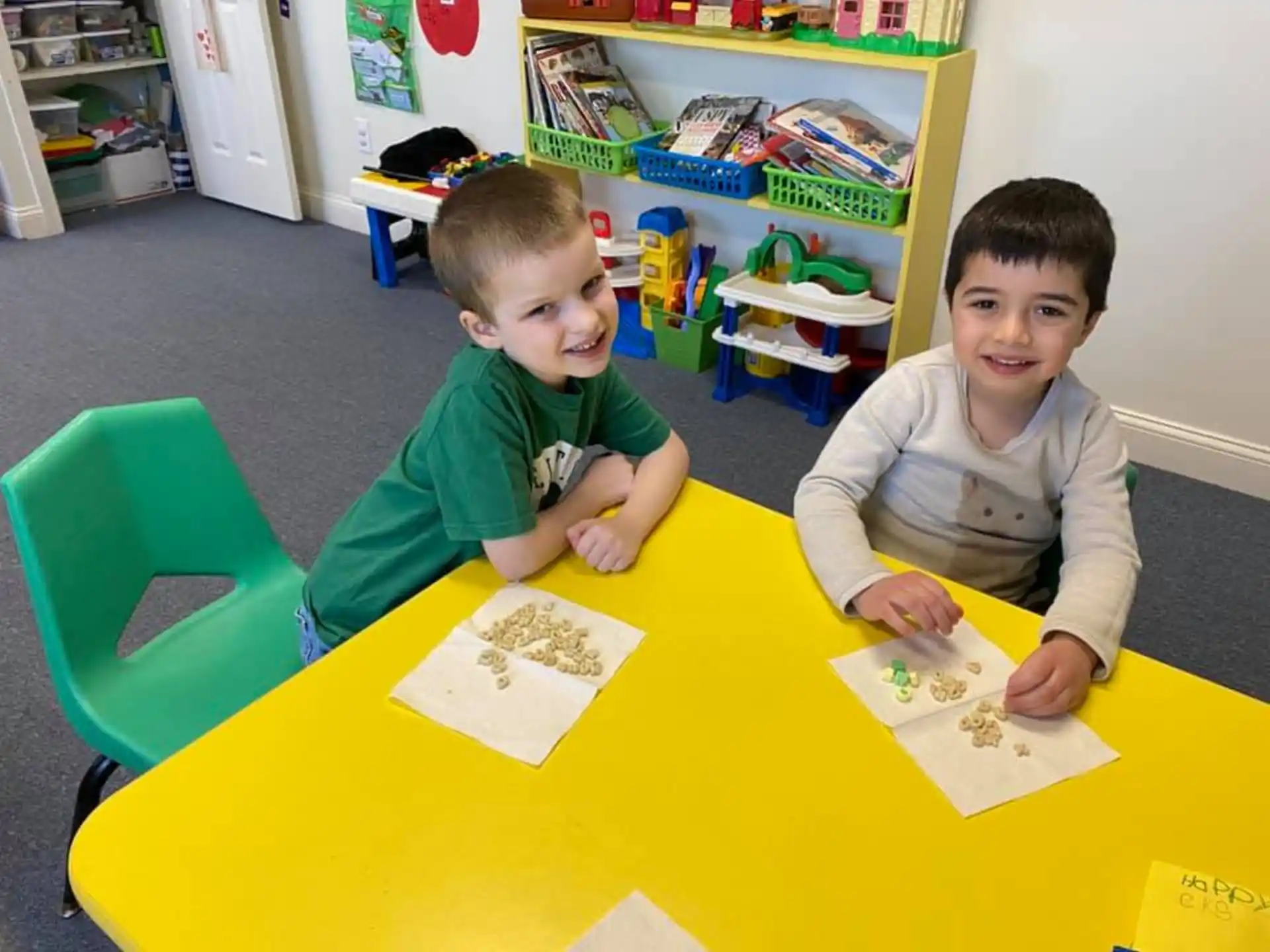 two boys sitting at a table