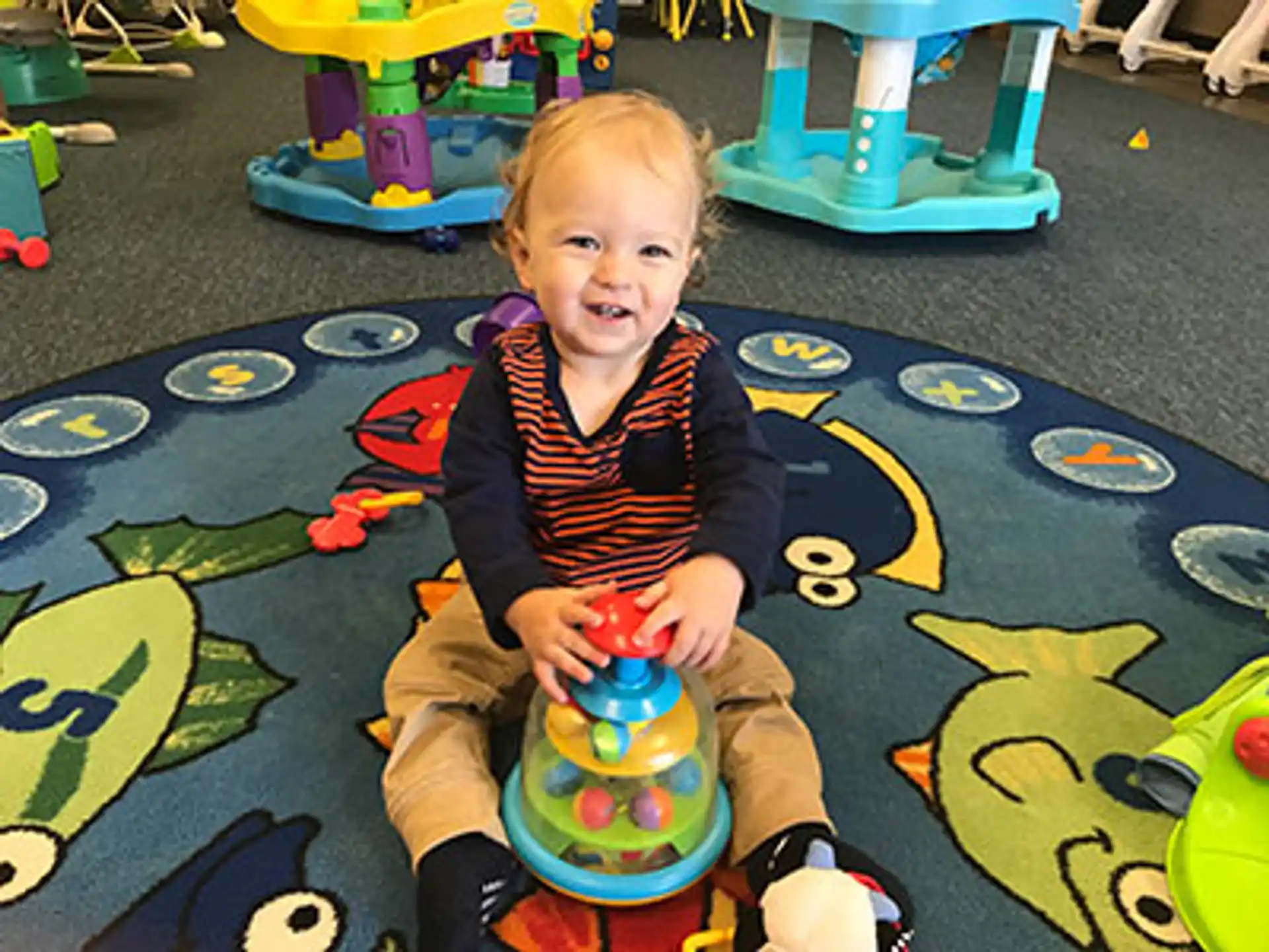 a child sitting on a toy